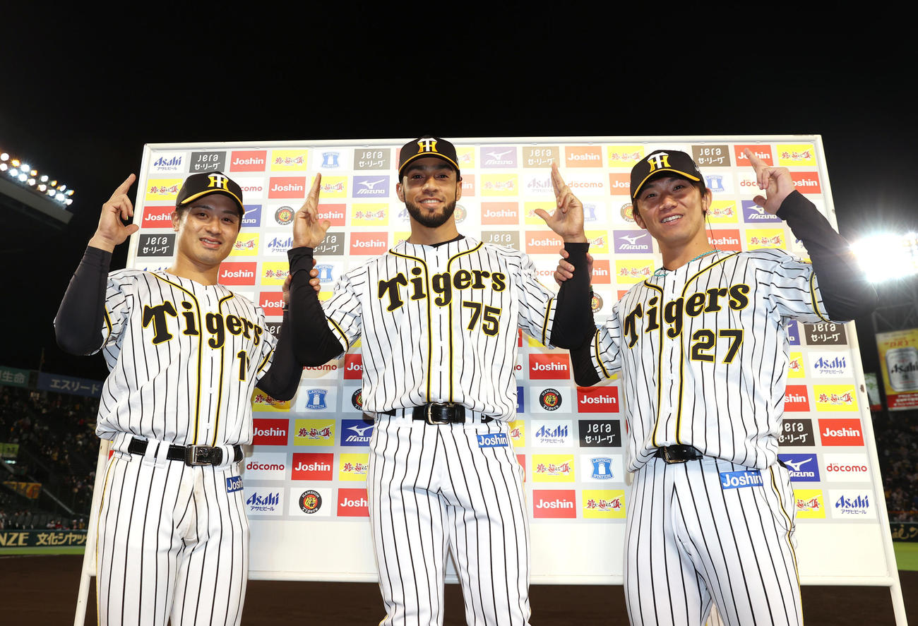お立ち台でポーズを取るヒーローの阪神坂本（左）、スアレス（中央）、伊藤将（撮影・清水貴仁）