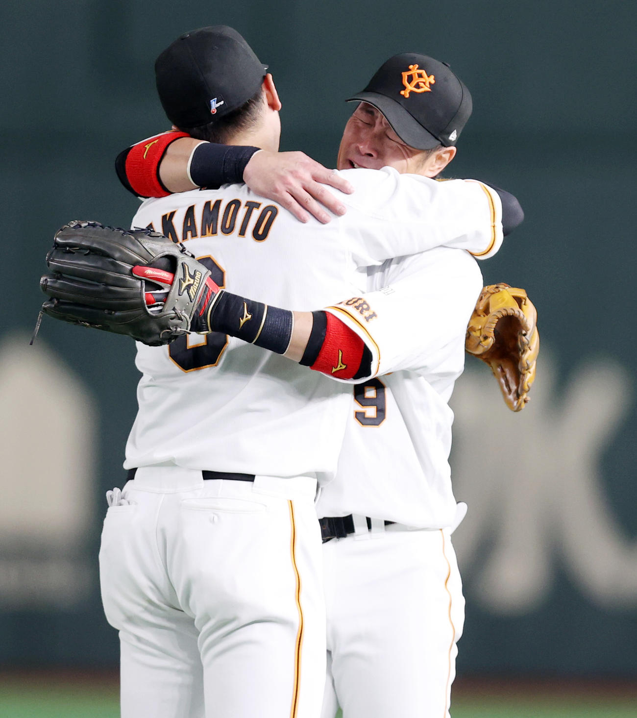 巨人対ヤクルト　6回表、いったん守備に就く亀井義行（右）は、原監督から交代を告げられ、待ち受ける坂本（左）と抱き合い号泣する（撮影・狩俣裕三）
