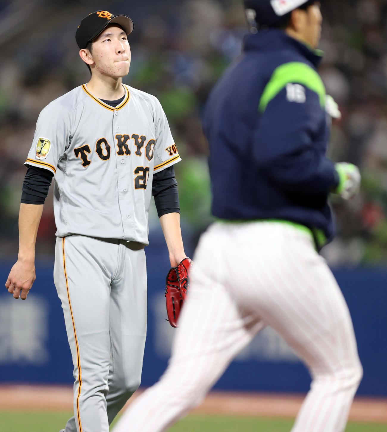 ヤクルト対巨人　4回裏を終え、この回に原（手前）から3点適時二塁打を打たれ、悔しそうにベンチに戻る戸郷（撮影・狩俣裕三）
