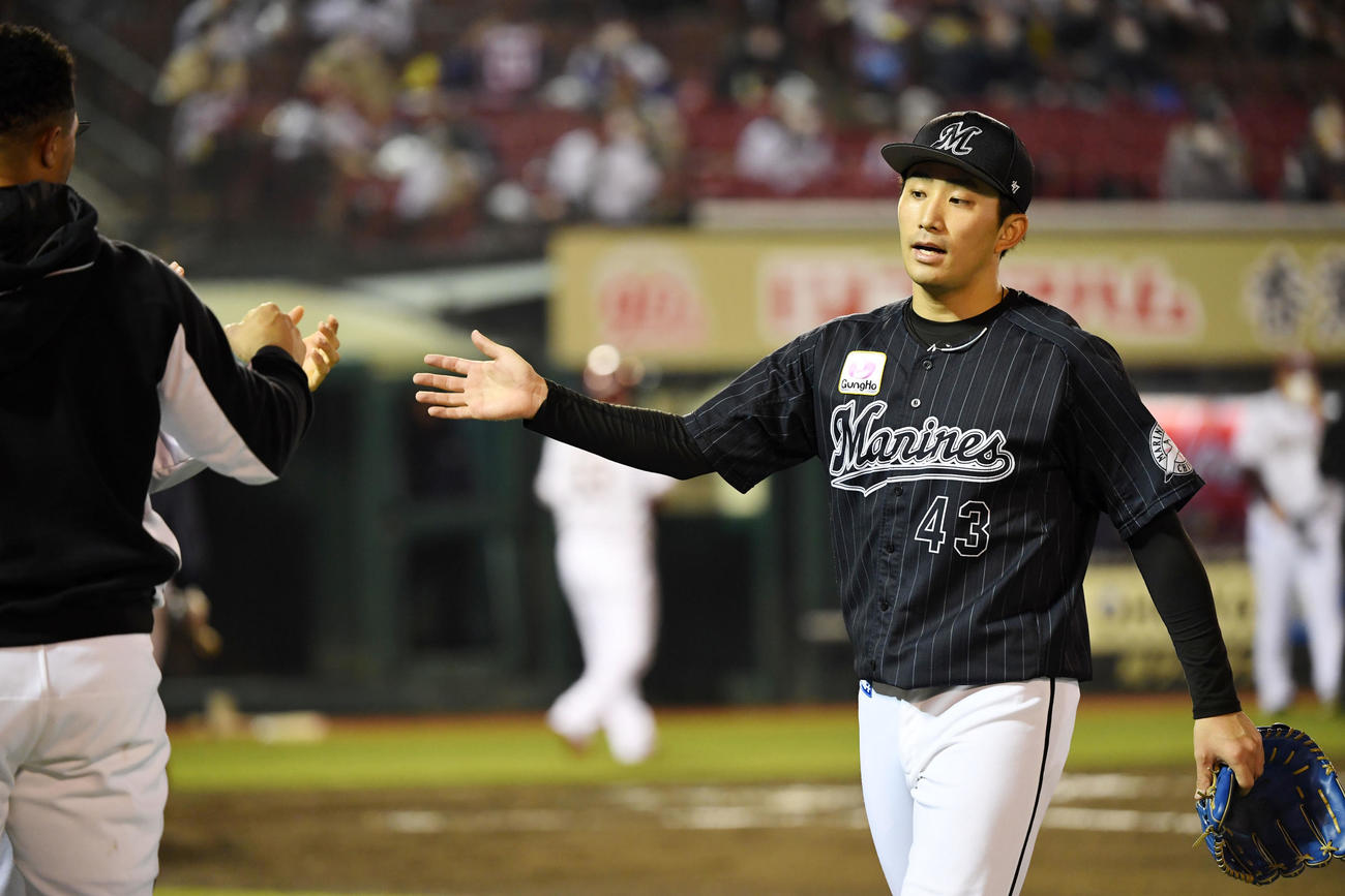 楽天対ロッテ　6回裏を無失点に抑えタッチを交わすロッテ小島（撮影・横山健太）