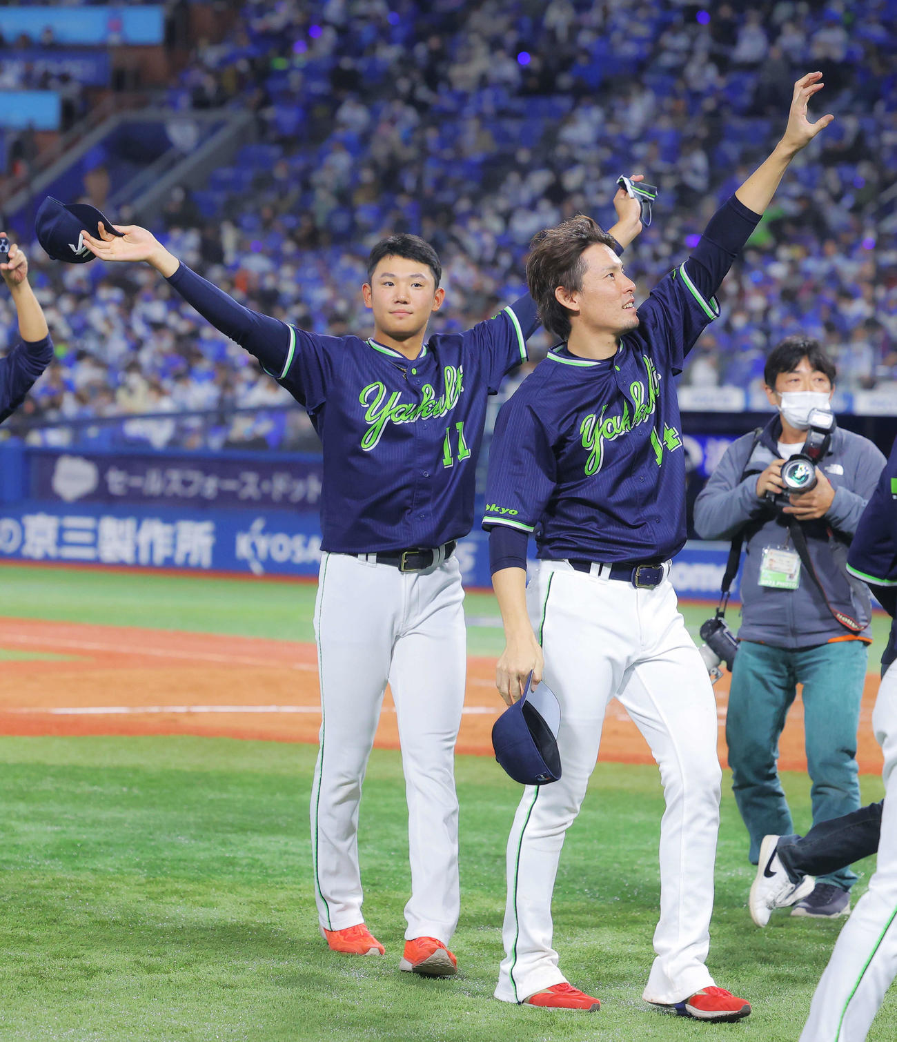 セ・リーグ優勝を決め、観客に手を振り応えるヤクルト奥川（左）と高梨（撮影・河田真司）