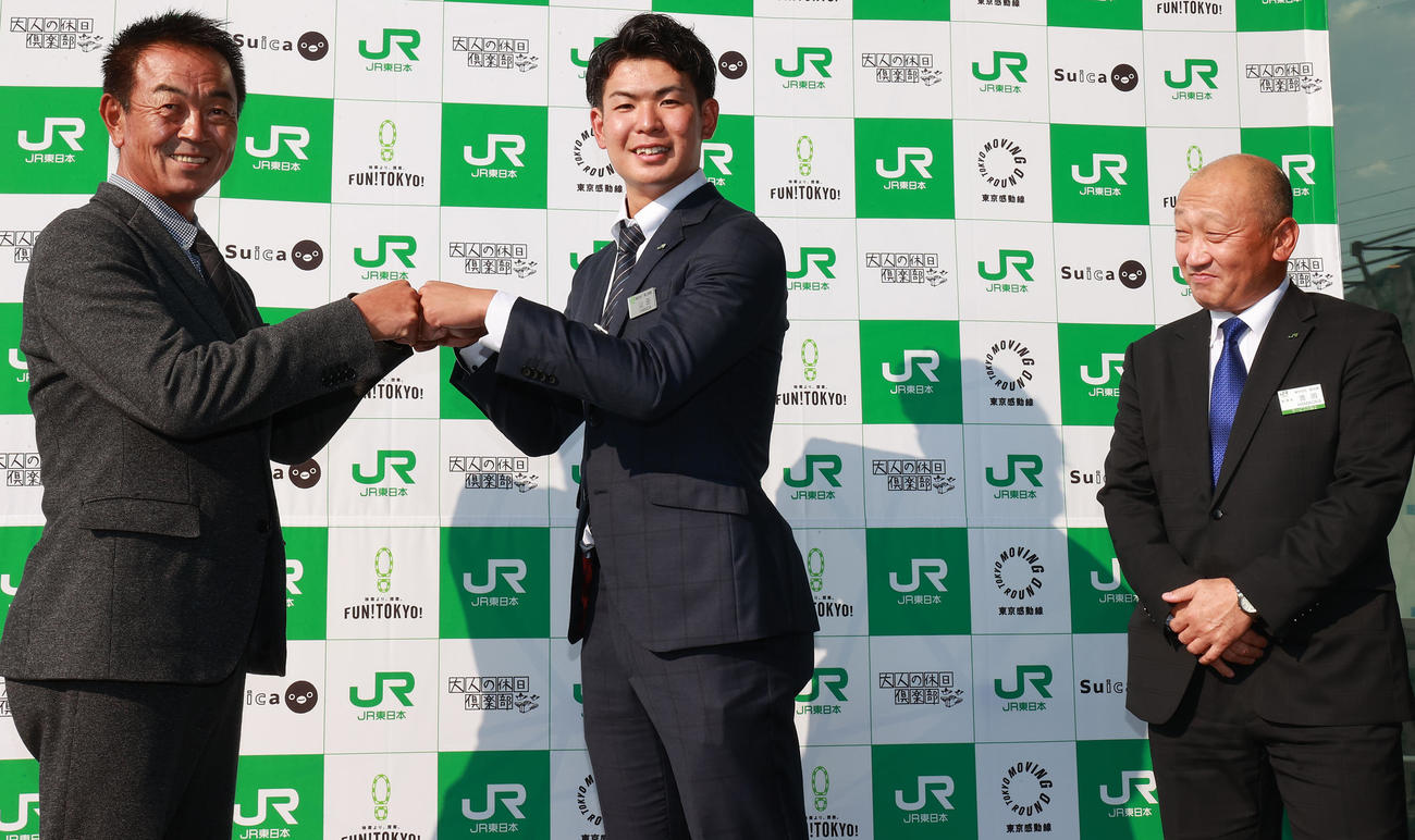 巨人ドラフト2位のJR東日本・山田（中央）は、指名あいさつを受け巨人水野スカウト部長（左）とグータッチ。右はJR東日本・浜岡監督（撮影・野上伸悟）