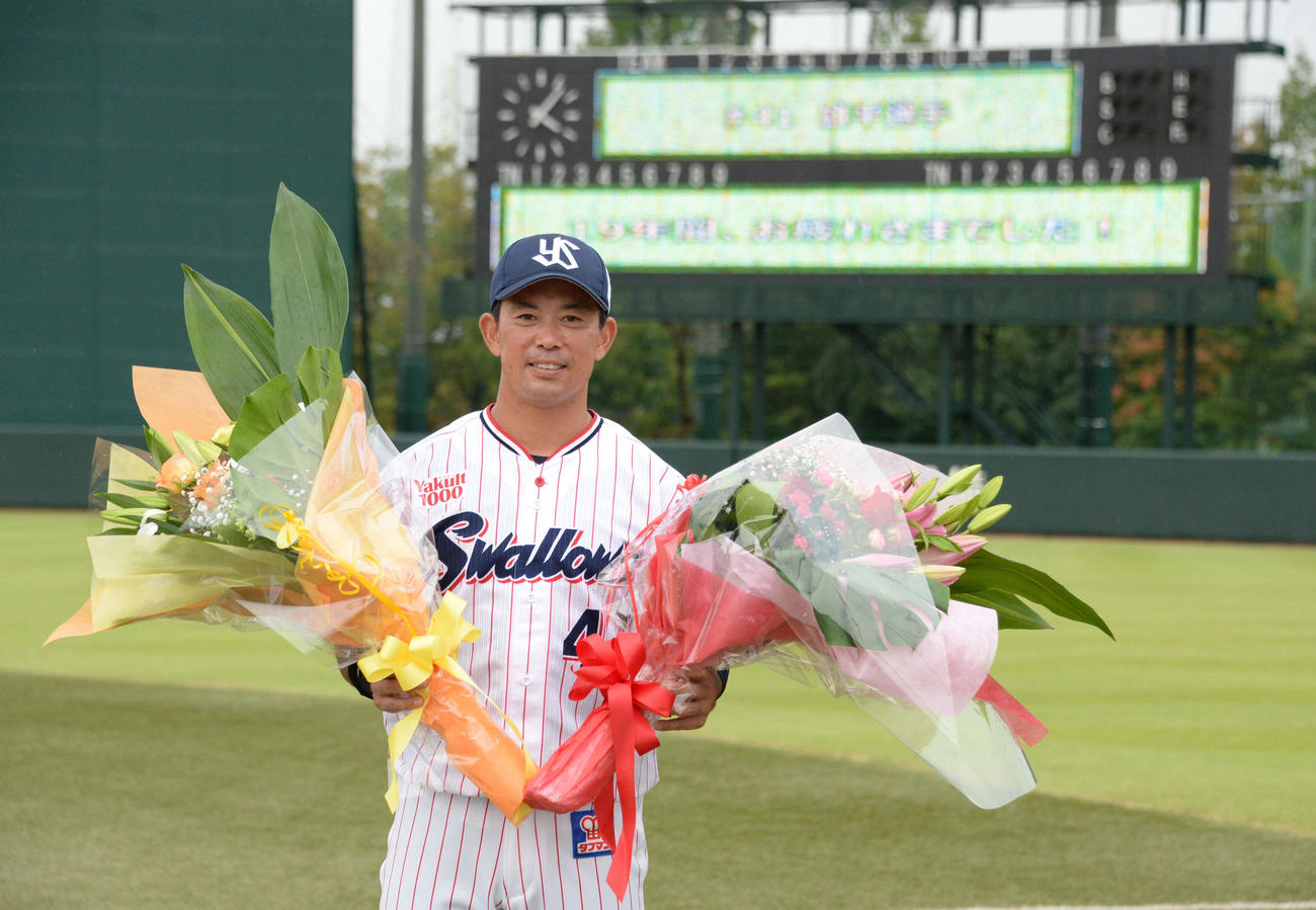 ヤクルト雄平は花束を手に笑顔を見せる（2021年9月30日撮影）