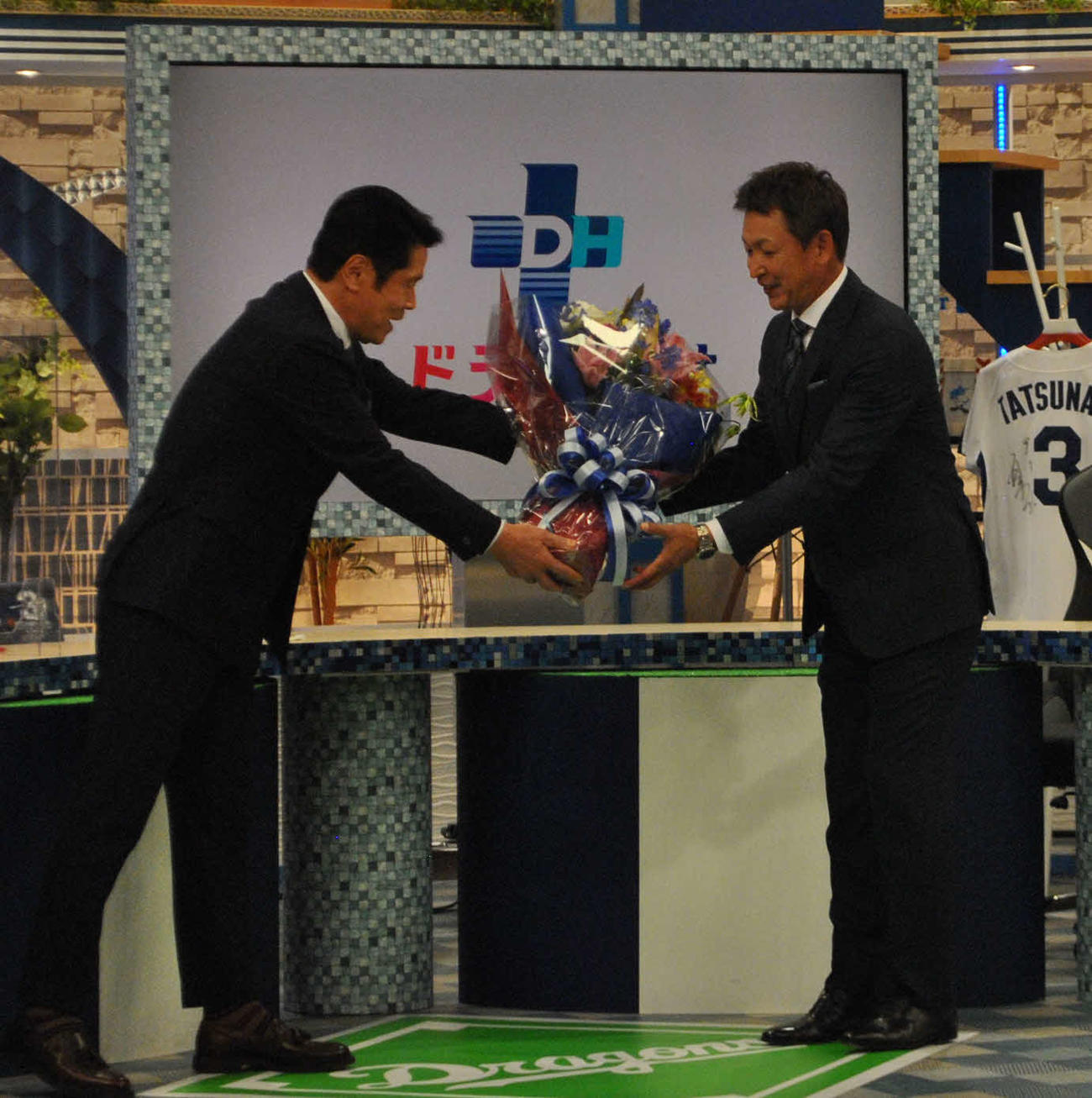 地元テレビ局の情報番組でタレント峰竜太（左）から花束を贈られる中日立浪新監督（撮影・伊東大介）