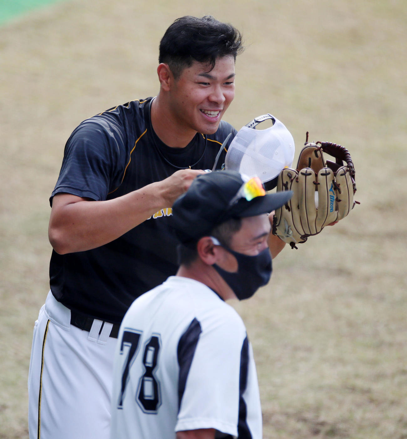 ロッテ対阪神　近大の先輩にあたるロッテ大隣コーチ（右）にあいさつする佐藤輝（撮影・加藤哉）