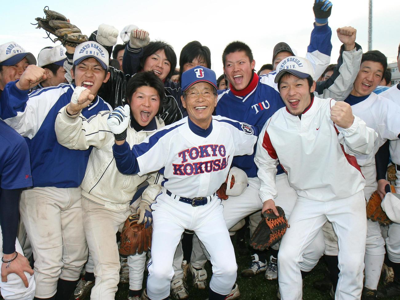 2008年2月、東京国際大の監督に就任した古葉竹識さんは、ナインと笑顔でガッツポーズ