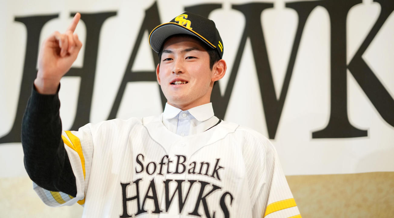 仮契約を終えたソフトバンクドラフト1位のノースアジア大明桜・風間は1本指を立て笑顔を見せる（撮影・横山健太）