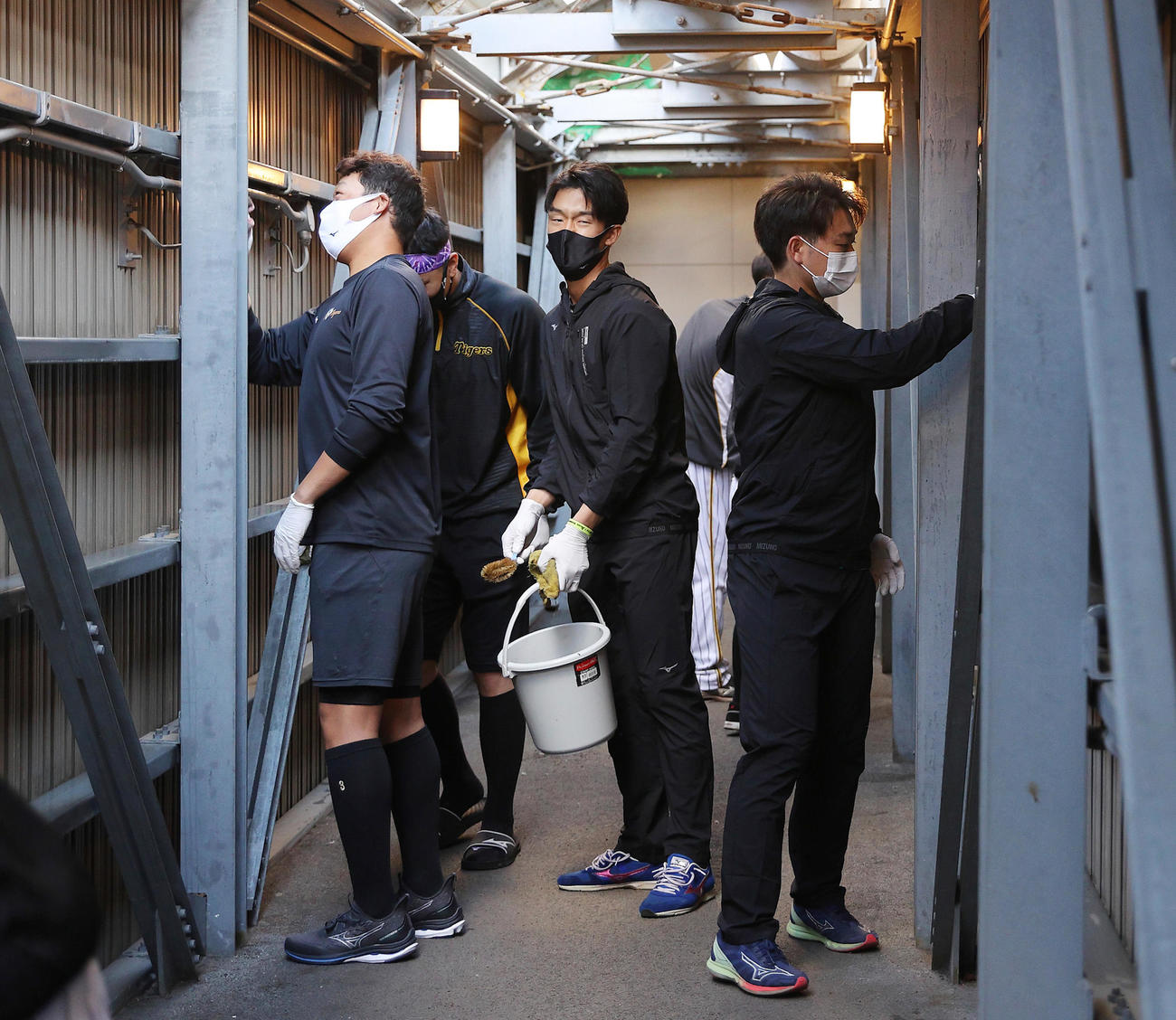 甲子園で大掃除を行う阪神の選手たち、左から大山悠輔、佐藤輝明、小幡竜平、山本泰寛（阪神球団提供）