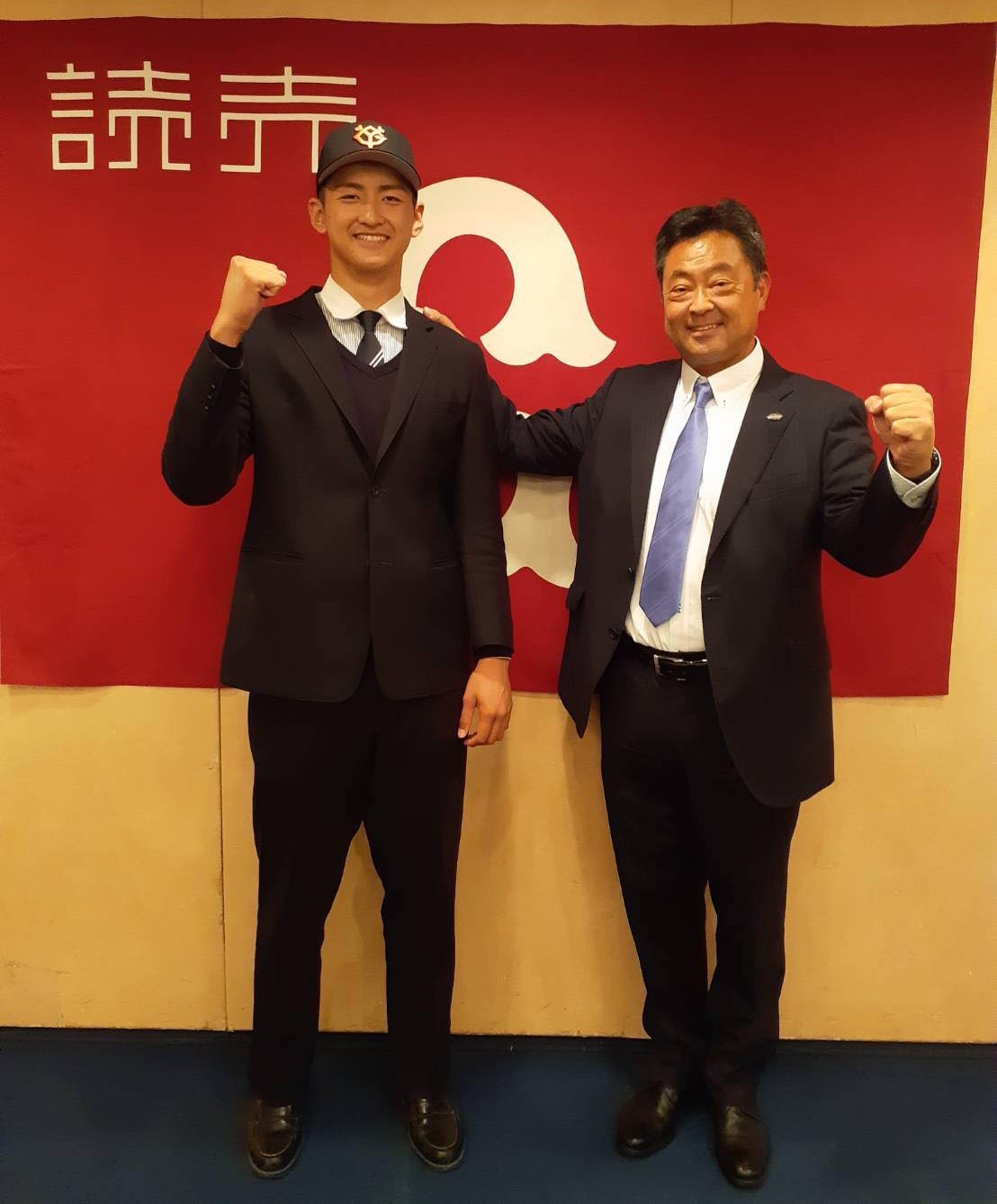 仮契約を結んだ巨人育成ドラフト5位の創成館・鴨打は担当の武田スカウトとガッツポーズ（球団提供）