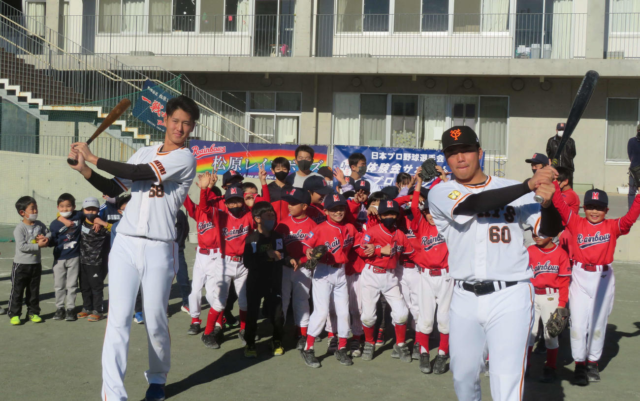 小学生を前に打撃フォームを見せる巨人秋広（左）と菊田（撮影・上田悠太）