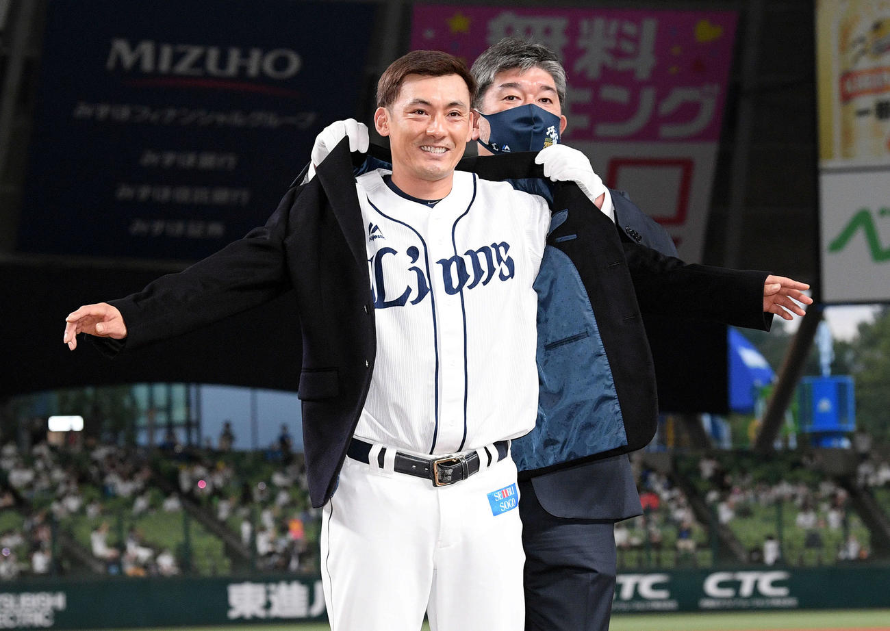 野茂英雄氏（奥）から名球会ブレザーを着させてもらう西武栗山（2021年9月15日撮影）