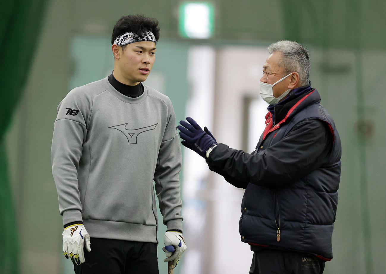 母校近大のグラウンドで自主トレを公開し、練習の合間に近大・田中監督（右）と言葉を交わす阪神佐藤輝（撮影・前田充）