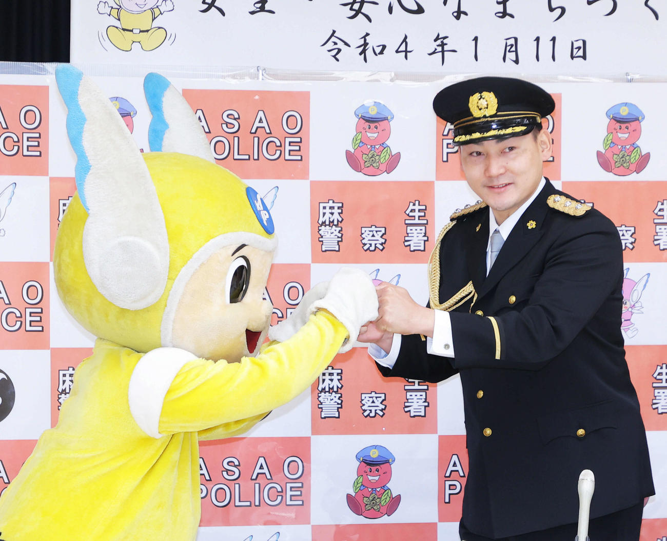 神奈川県警マスコットのピーガルくんとグータッチを交わす、麻生警察署の一日警察署長を務める巨人丸（撮影・河田真司）