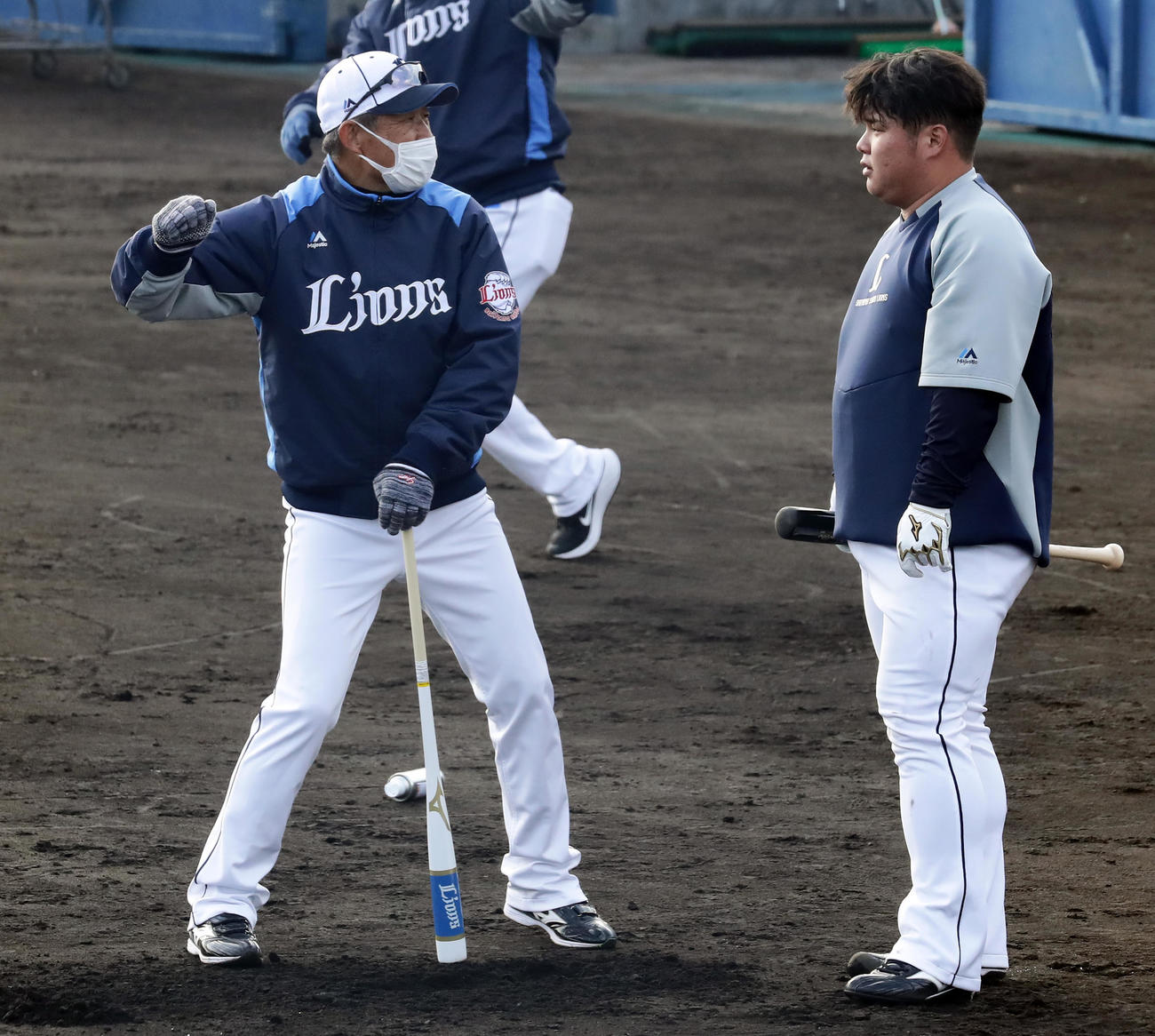 西武春季キャンプ初日、辻監督（左）から打撃指導を受ける渡部（撮影・浅見桂子）
