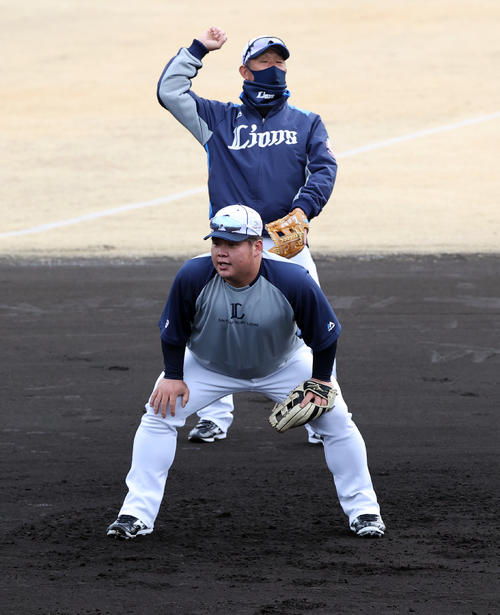 西武の春季キャンプ2日目、辻監督（奥）が見つめる中、早出の渡部はノックを受ける（撮影・浅見桂子）
