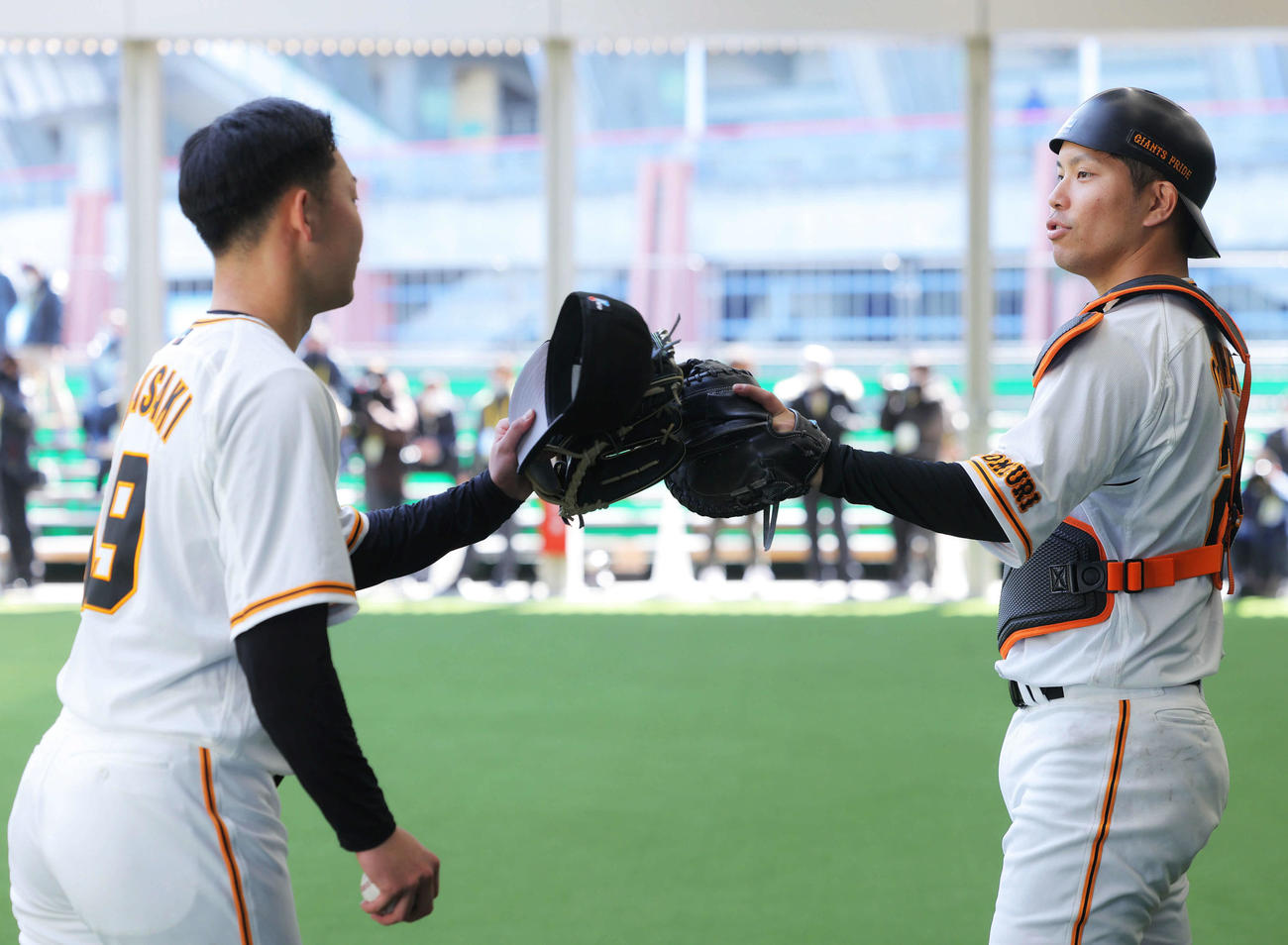 ブルペン投球を終え、グラブタッチする巨人山崎伊（左）と大城（撮影・河田真司）