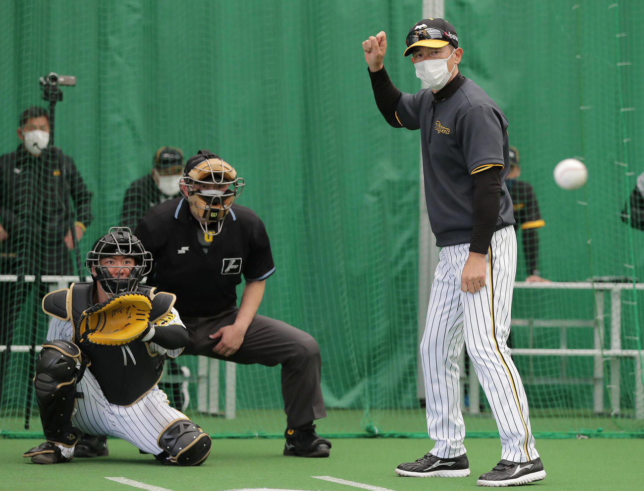 ブルペンで湯浅の打席に立つ矢野監督。捕手は長坂（撮影・前田充）