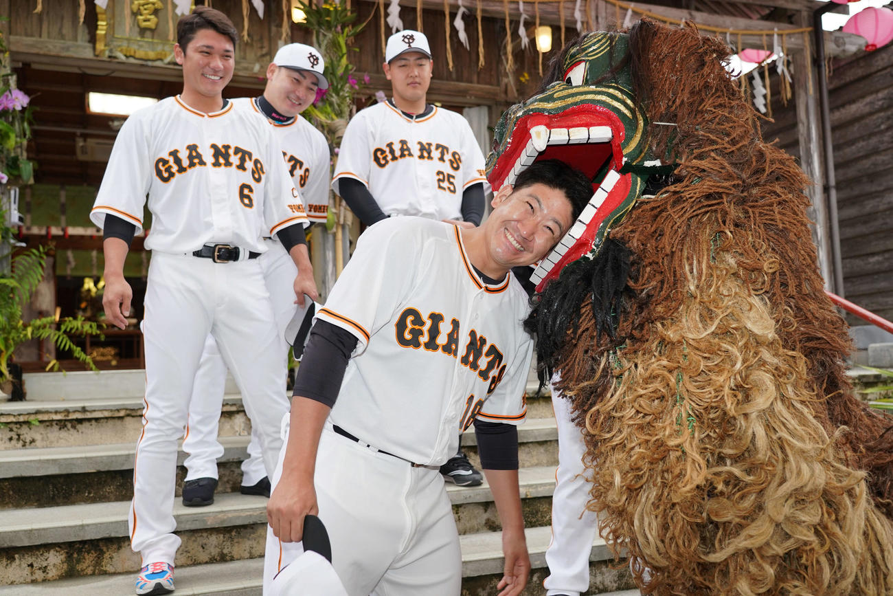 沖宮を参拝し、獅子舞に頭をかまれる巨人菅野（手前）。後方左から坂本、丸、岡本和