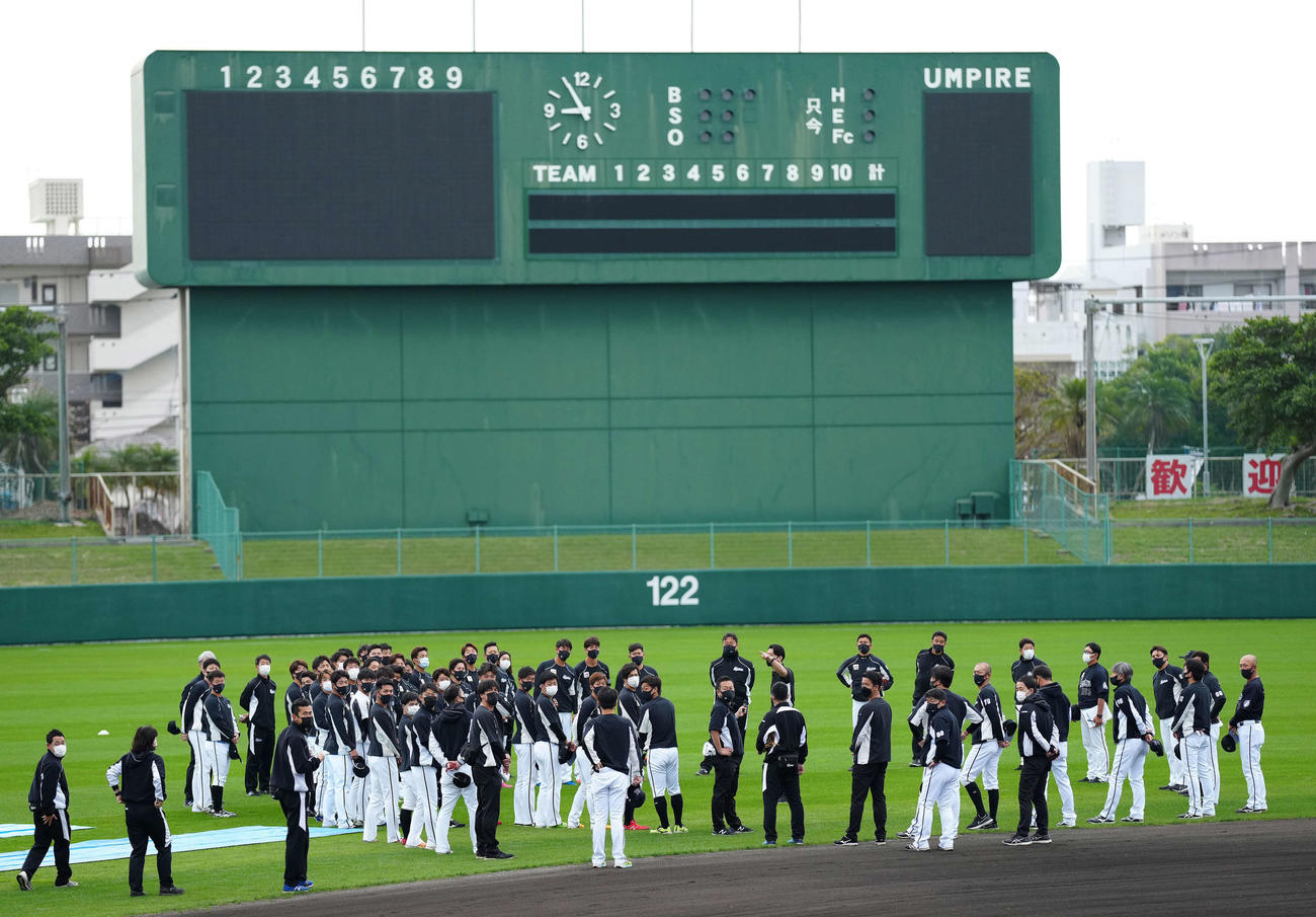 2次キャンプが行われる沖縄・糸満市西崎球場で円陣を組むロッテの選手たち（2022年2月16日撮影）