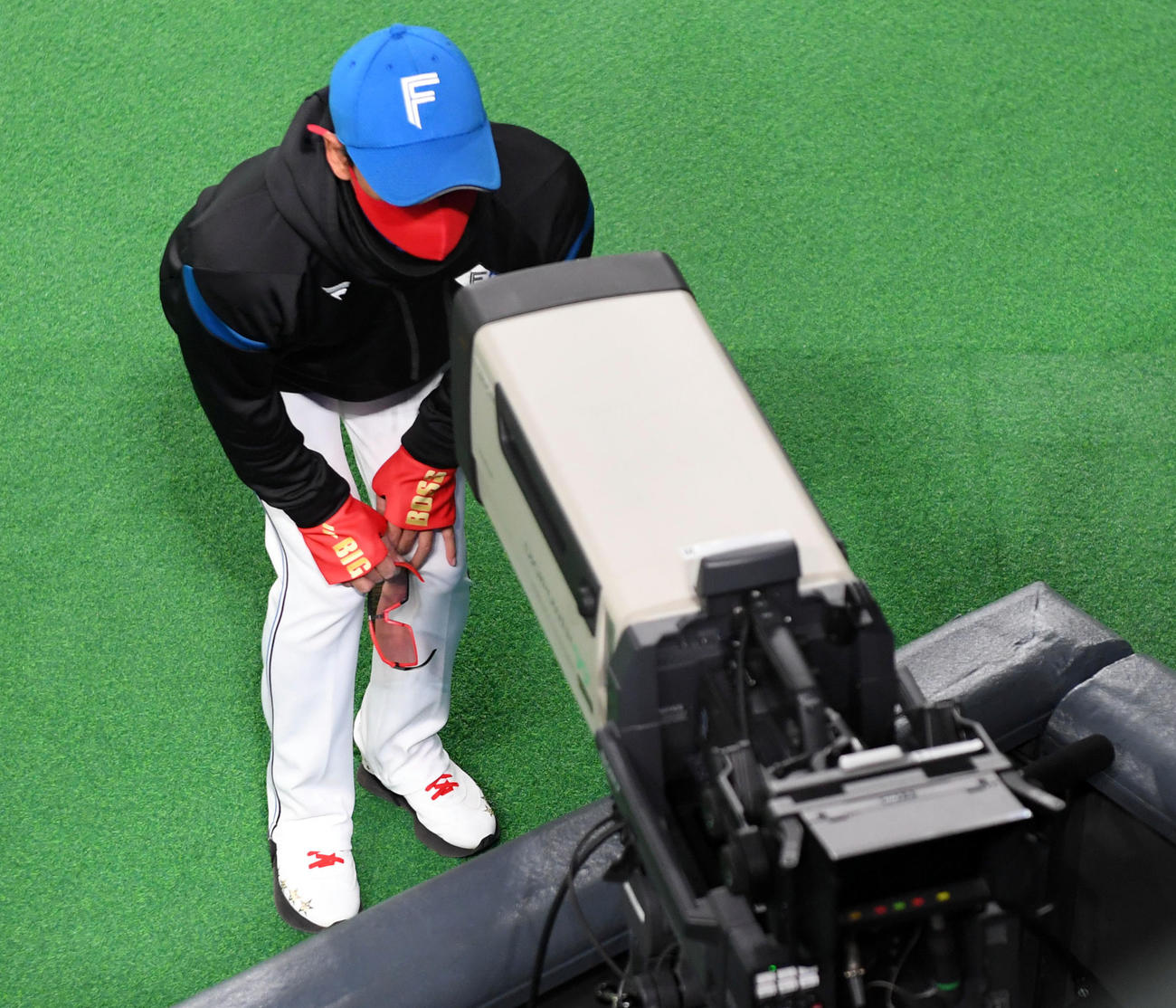 テレビカメラをのぞき込む日本ハム新庄監督（撮影・たえ見朱実）