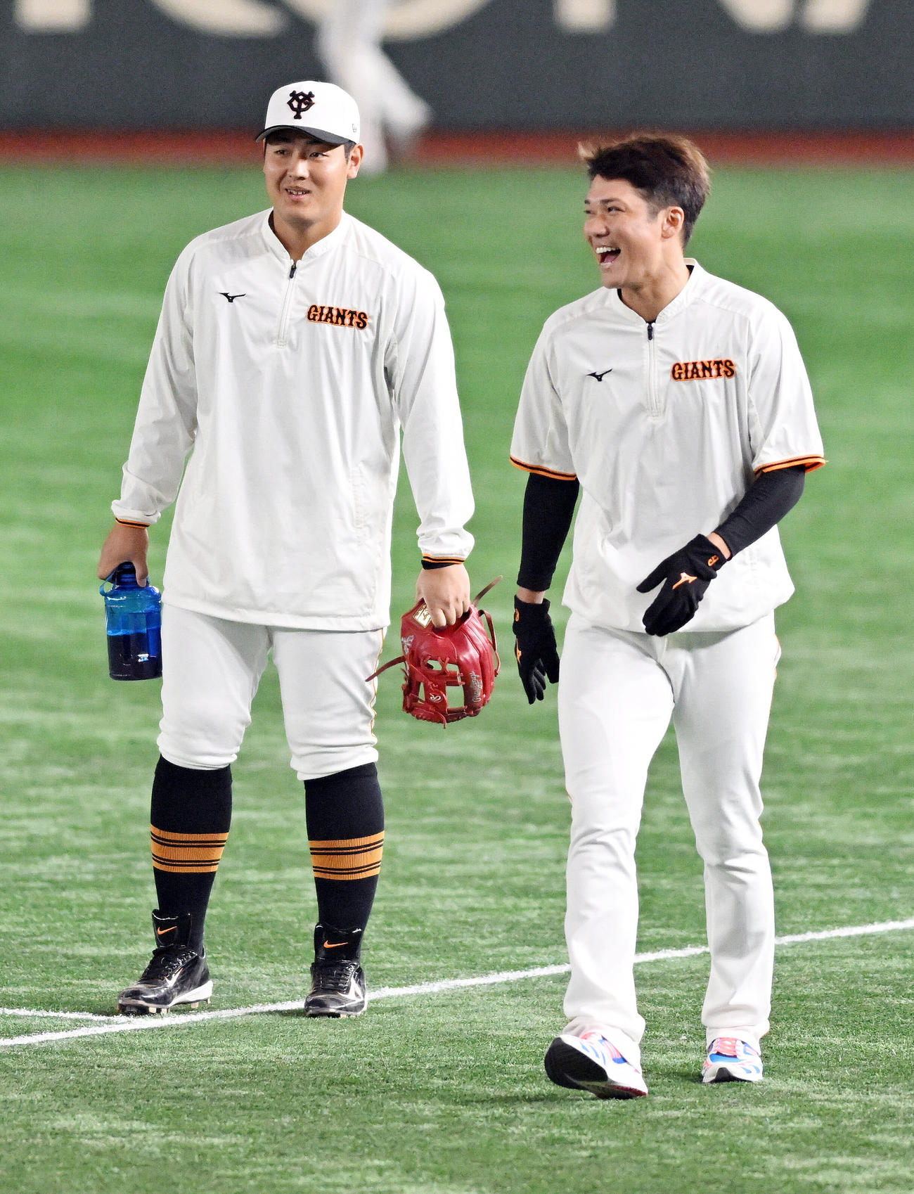 巨人対西武　試合前練習で言葉を交わし笑顔の巨人岡本和（左）と坂本（撮影・滝沢徹郎）