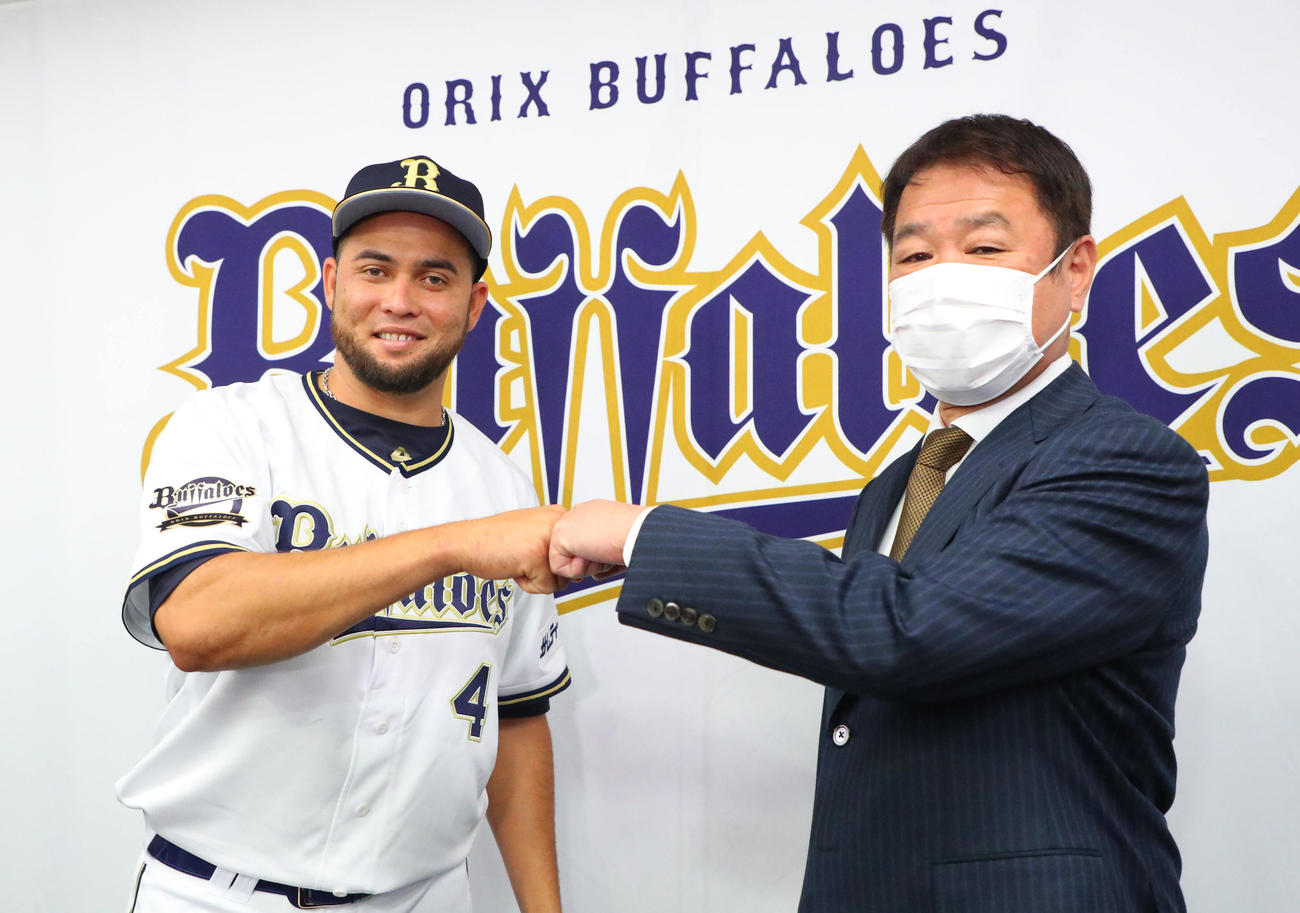 オリックス入団を発表し、福良GM（右）と拳を合わせるバレラ（撮影・宮崎幸一）