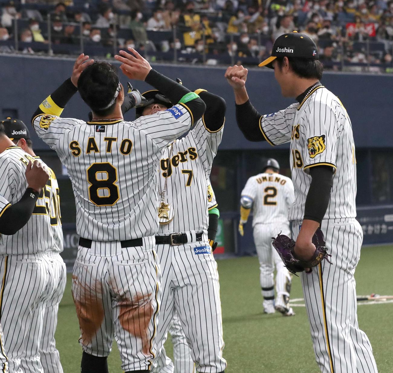 阪神対ヤクルト　4回裏阪神2死一塁、右越え2点本塁打を放った糸井は佐藤輝（左）藤浪（右）と喜び合う（撮影・上田博志）