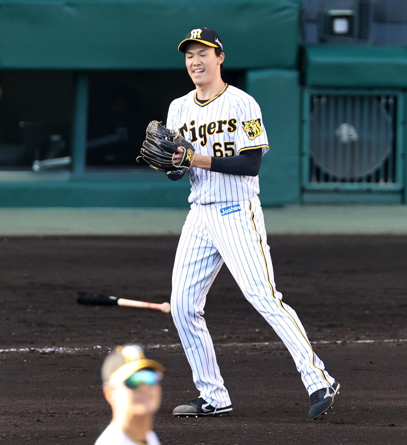 阪神対巨人　8回表巨人2死二塁、湯浅は岡本和を中飛に仕留めグラブを叩く（撮影・加藤哉）