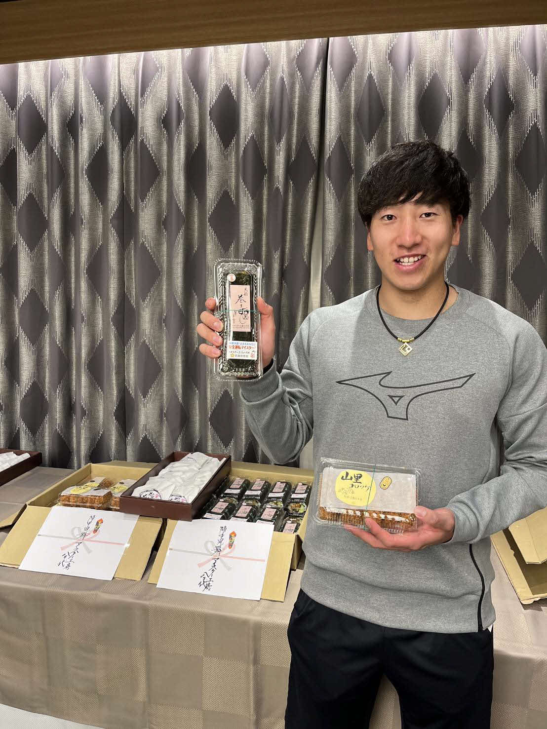 実家近くにある巻きずしの有名店「マイスター工房八千代」からの差し入れに笑顔を見せる巨人ドラフト1位・大勢（藤原さん提供）