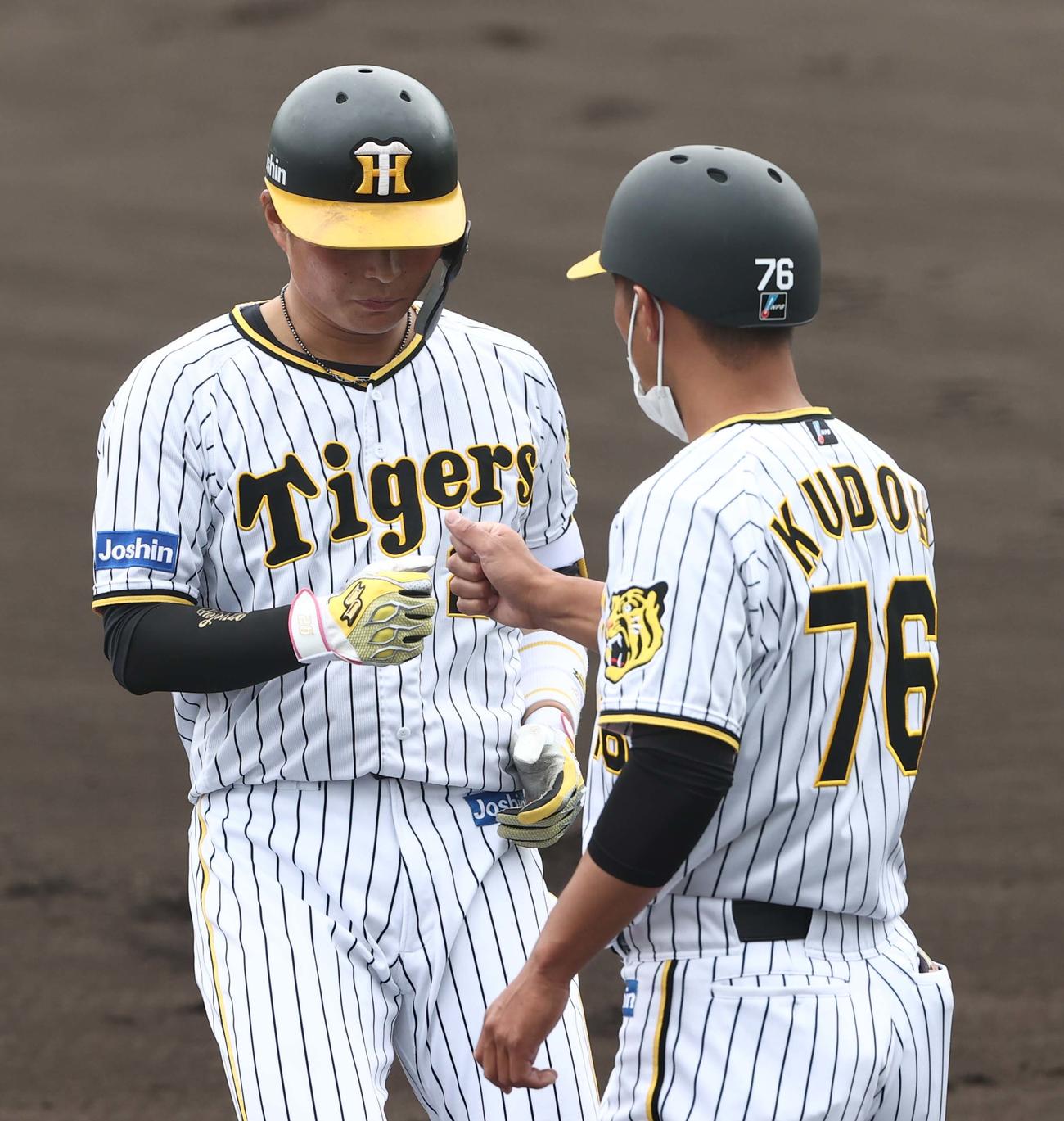 阪神ファーム対カナフレックス　1回裏阪神無死一塁、左前安打を放ち工藤隆人コーチとグータッチする北條史也（撮影・上田博志）