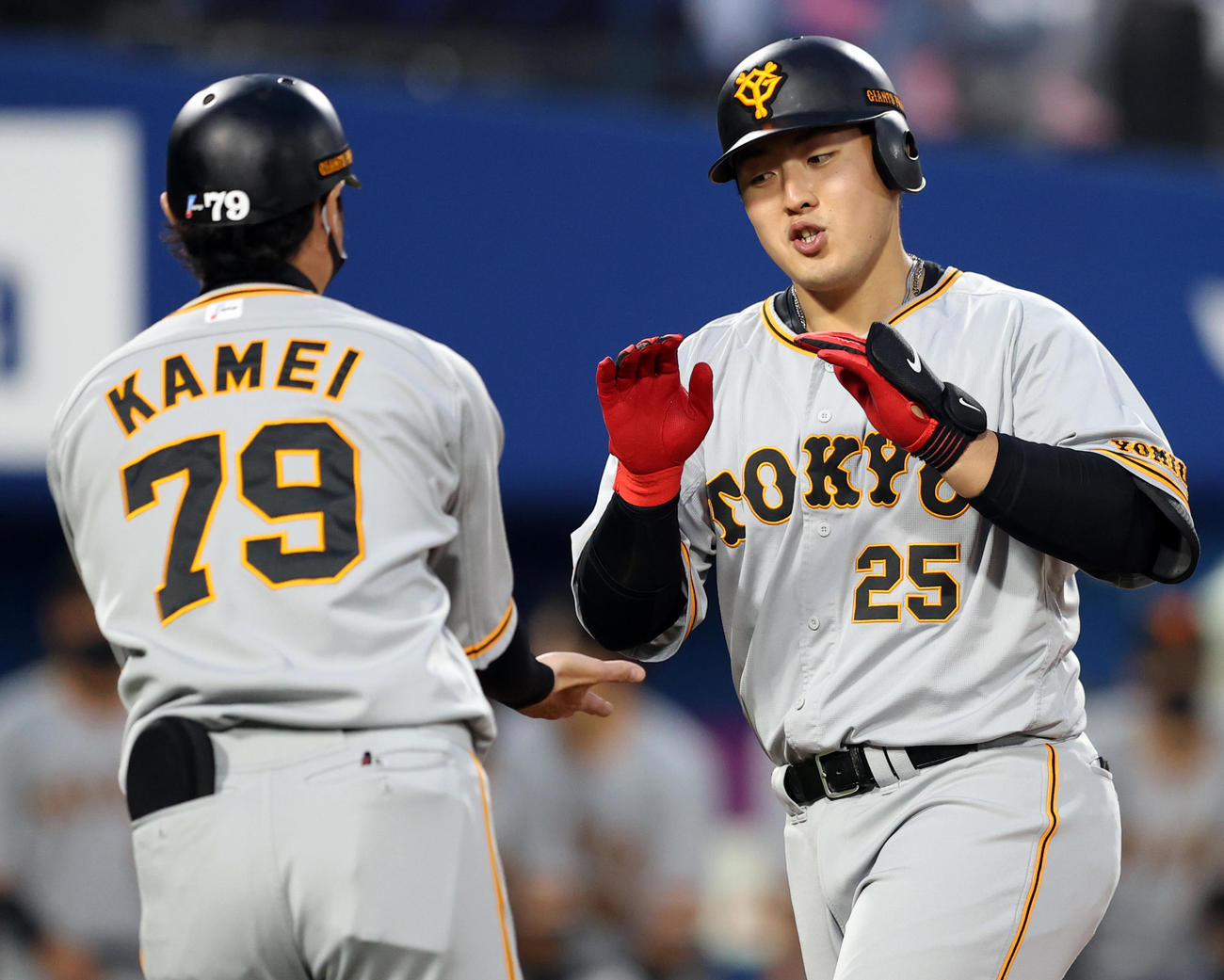 DeNA対巨人　1回表巨人2死二塁、先制2点本塁打を放ち亀井コーチ（左）とタッチを交わす岡本和（撮影・狩俣裕三）