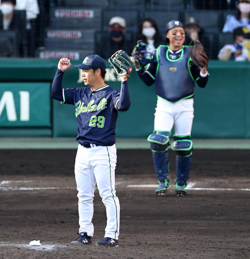 阪神対ヤクルト　9回裏阪神2死一塁、小川は大山を右飛に仕留めマウンドでガッポーズを見せる。右は中村（撮影・加藤哉）