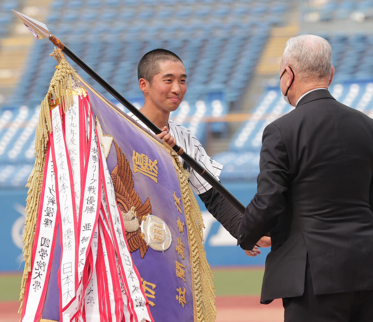 亜大対青学大　表彰式で優勝旗を受けとる亜大・田中幹主将（撮影・野上伸悟）