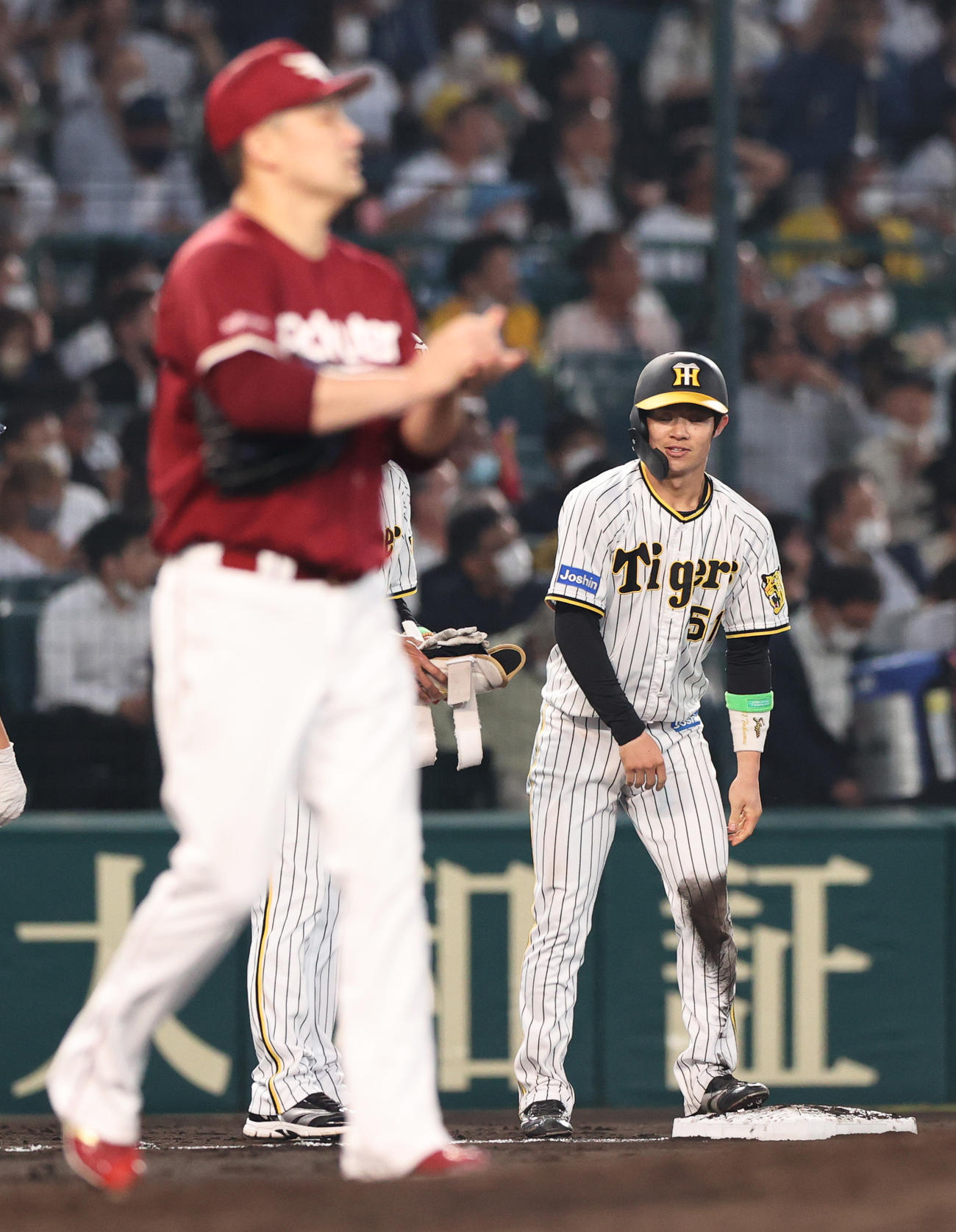 阪神対楽天　4回裏阪神無死、中野は右越え三塁打を放ち三塁で笑顔を見せる。手前は投手田中将（撮影・上山淳一）