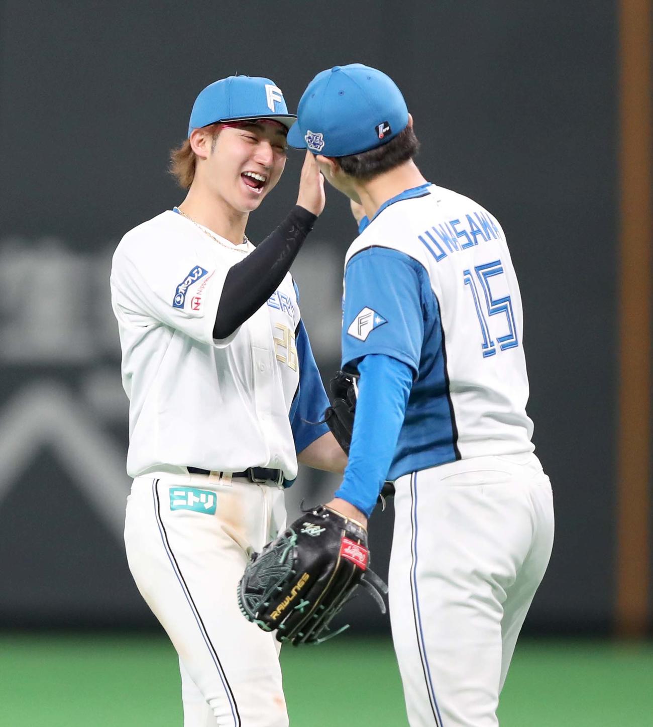 日本ハム対巨人　試合後、上沢（右）とタッチする浅間（撮影・黒川智章）