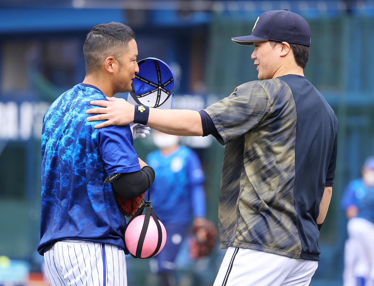 DeNA対オリックス　前日バットを当ててしまい謝るDeNA嶺井（左）に笑顔を見せるオリックス伏見（撮影・垰建太）