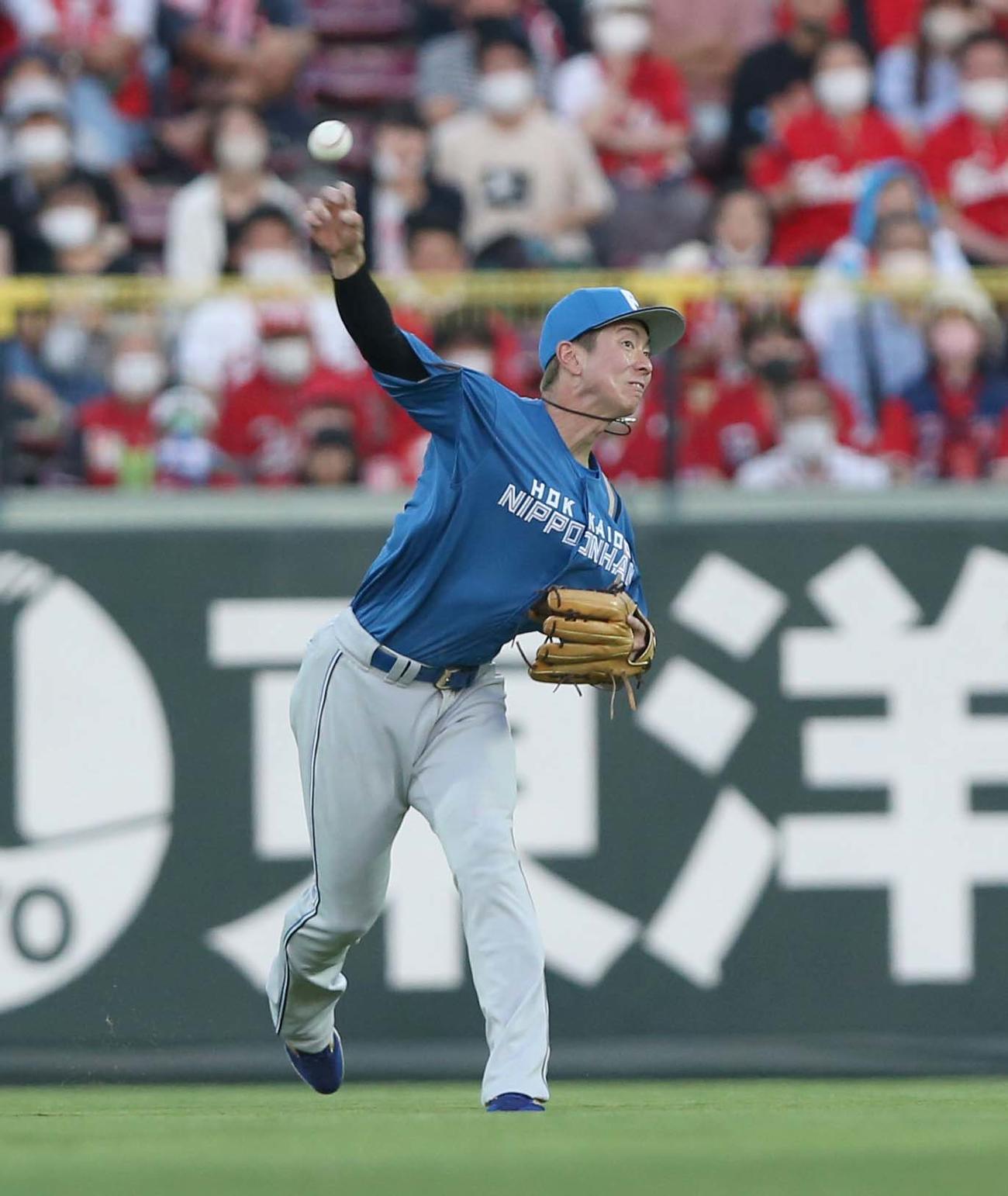 広島対日本ハム　3回裏広島1死一、三塁、マクブルームの中飛で松本剛が本塁で三塁走者の野間を補殺する（撮影・黒川智章）