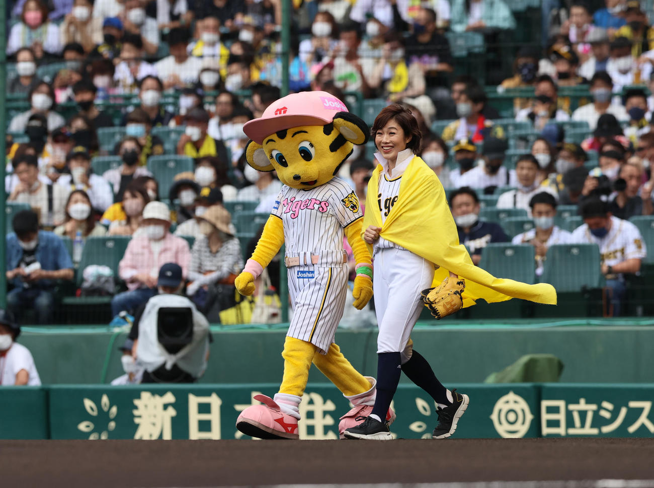 阪神対日本ハム　日本ハム新庄BIGBOSSバリのえりを立てて始球式のマウンドへ向かうフリーアナウンサー有働由美子さん（撮影・上山淳一）