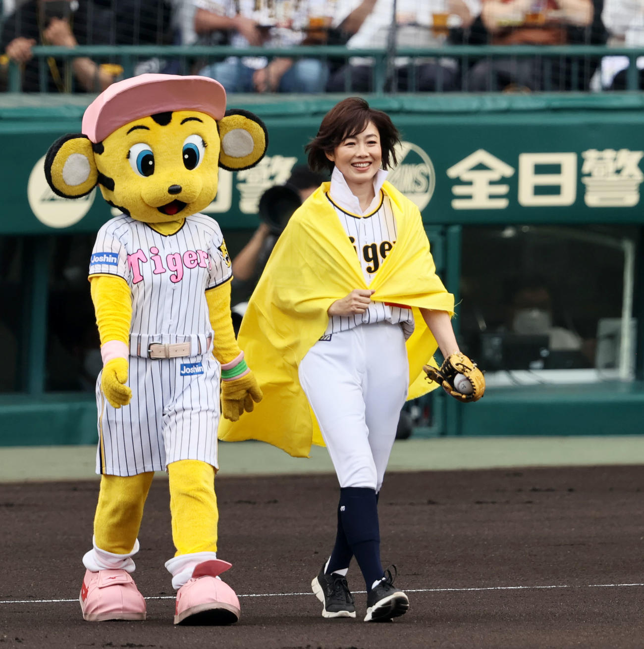 阪神対日本ハム　黄色の布をまとって始球式に向かう有働由美子さん（撮影・加藤哉）