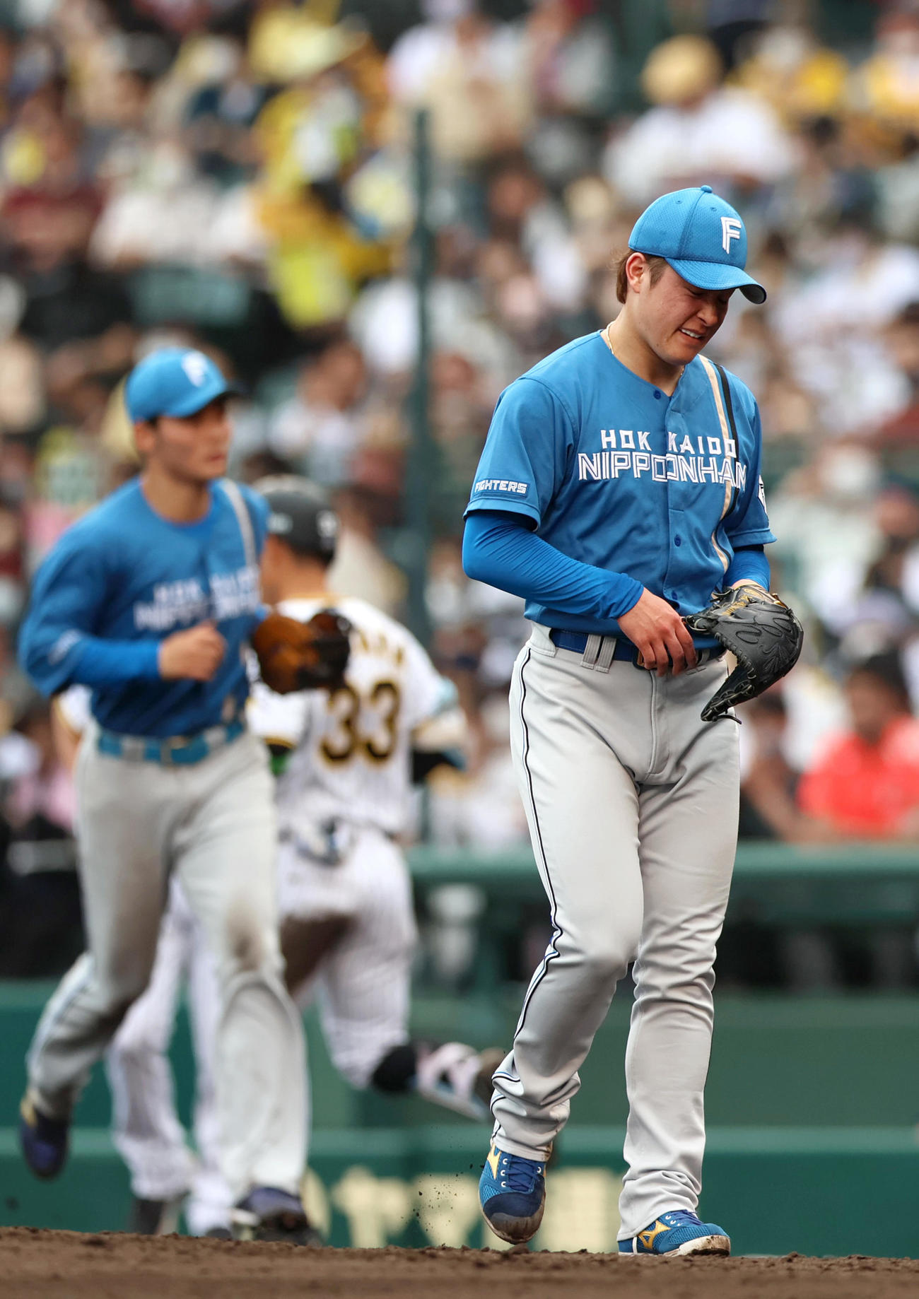 阪神対日本ハム　日本ハム吉田（右）は3回に4失点し、悔しげにベンチへ引き揚げる（撮影・上山淳一）