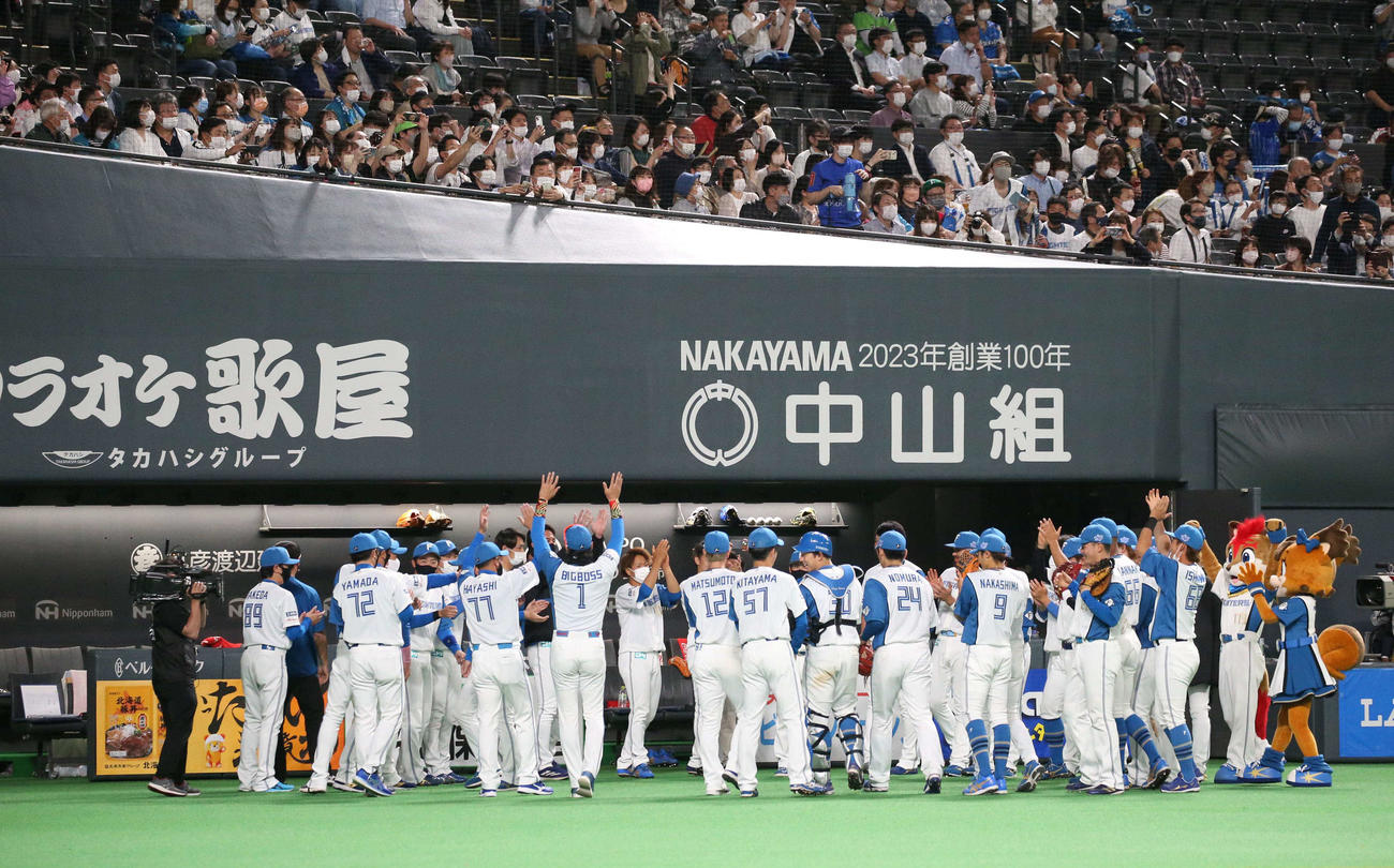 日本ハム対DeNA　試合後、ベンチ前で円陣を組み万歳する新庄監督（中央）とナイン（撮影・黒川智章）