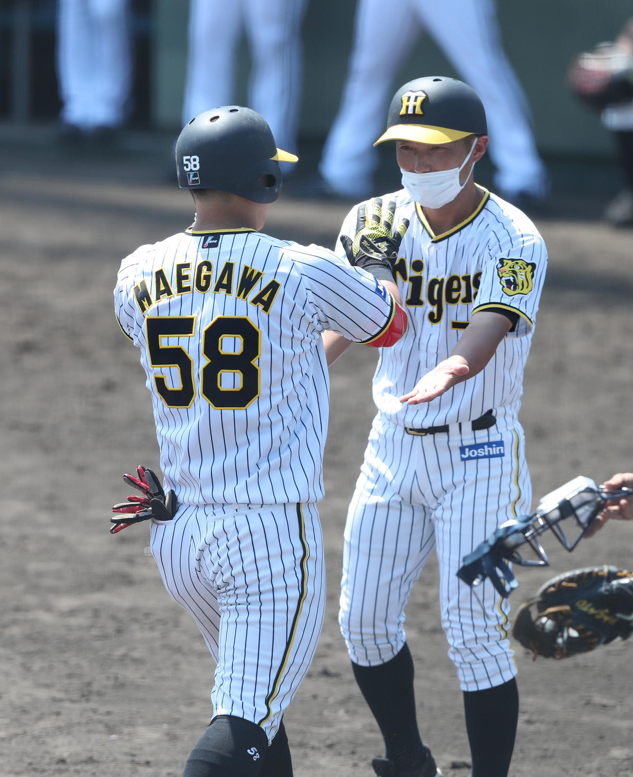 ウエスタン・リーグ阪神対オリックス　4回裏阪神1死一塁、左越え2点本塁打を放った前川（手前）は生還して工藤コーチとタッチを交わす（撮影・白石智彦）