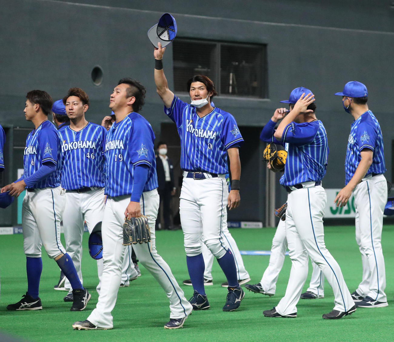 日本ハム対DeNA　スタンド応援席のファンに手を振りながら引き揚げるDeNA大田（中央）（撮影・佐藤翔太）