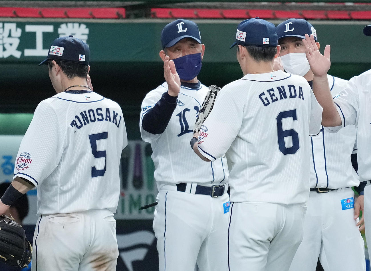 広島に勝利し、源田（右から2人目）をタッチで迎える西武辻監督（左から2人目）。右端は松井ヘッドコーチ（撮影・菅敏）