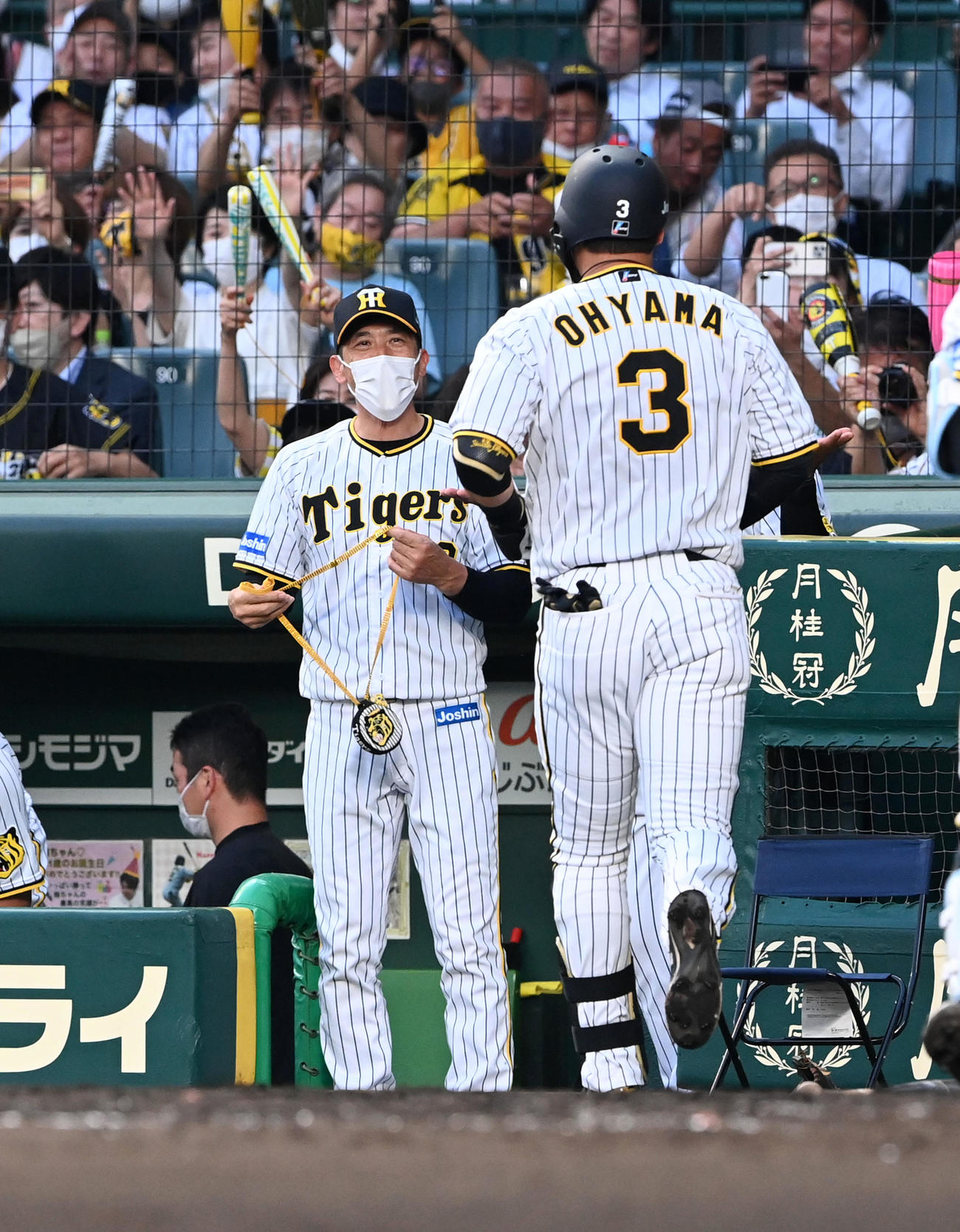 阪神対DeNA 3回裏阪神2死、左越え本塁打を放った大山（右）をメダルを手に笑顔で待つ矢野監督（撮影・前岡正明）