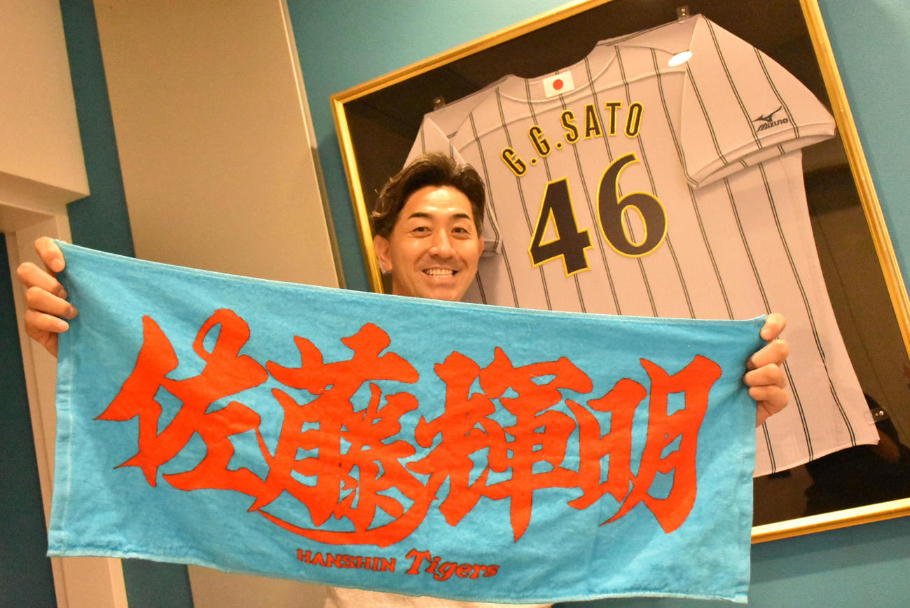 阪神佐藤輝明内野手の応援タオルを持つG・G・佐藤氏（撮影・真柴健）