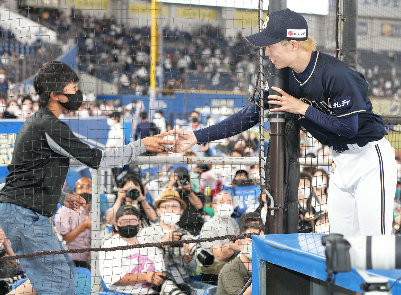 ロッテ対オリックス　完封勝利を挙げたオリックス山岡（右）は、ファンに勝利球をプレゼント（撮影・鈴木みどり）