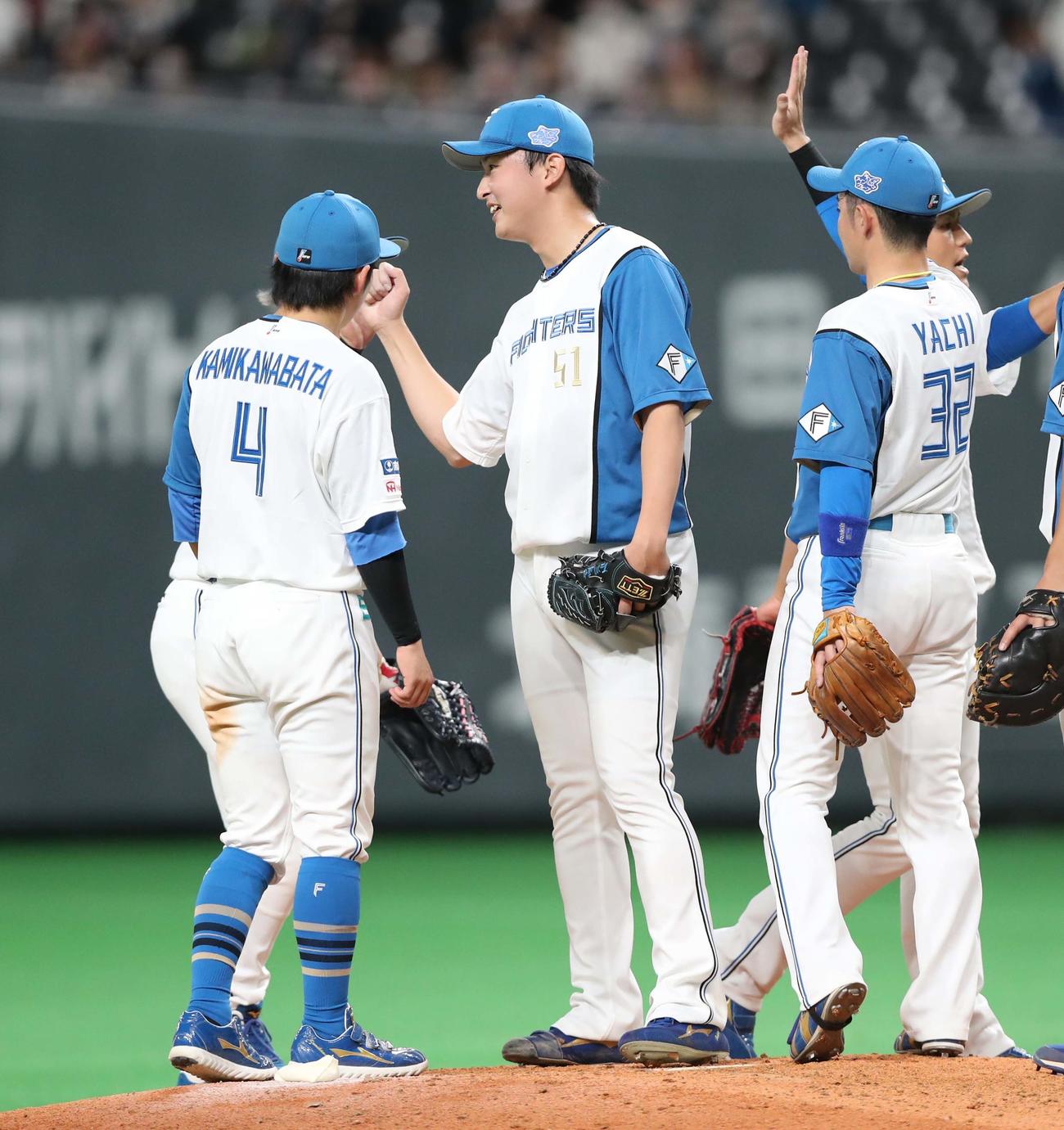 今季初セーブを挙げ笑顔の石川直（中央）（撮影・黒川智章）