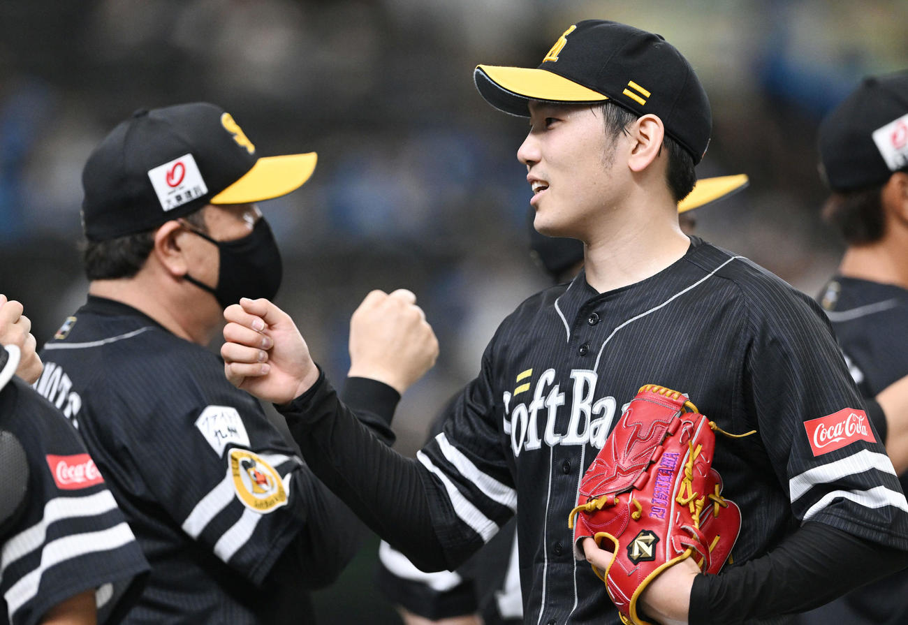 西武対ソフトバンク　完投勝利したソフトバンク石川（右）は藤本監督とタッチを交わす（撮影・滝沢徹郎）