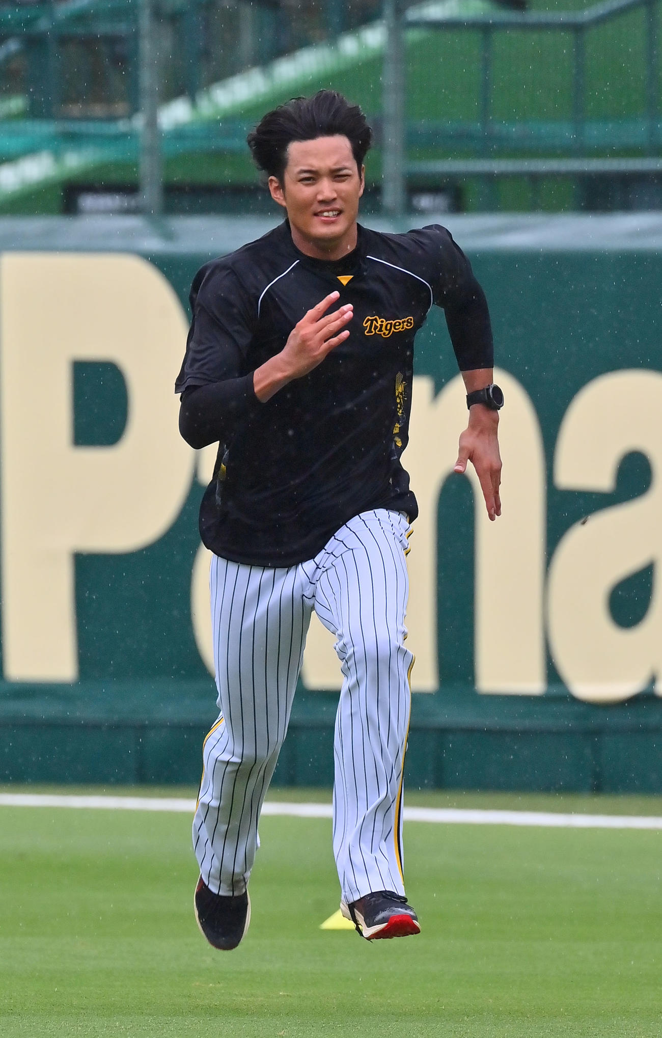雨の中、甲子園の外野を走り込む藤浪（撮影・和賀正仁）